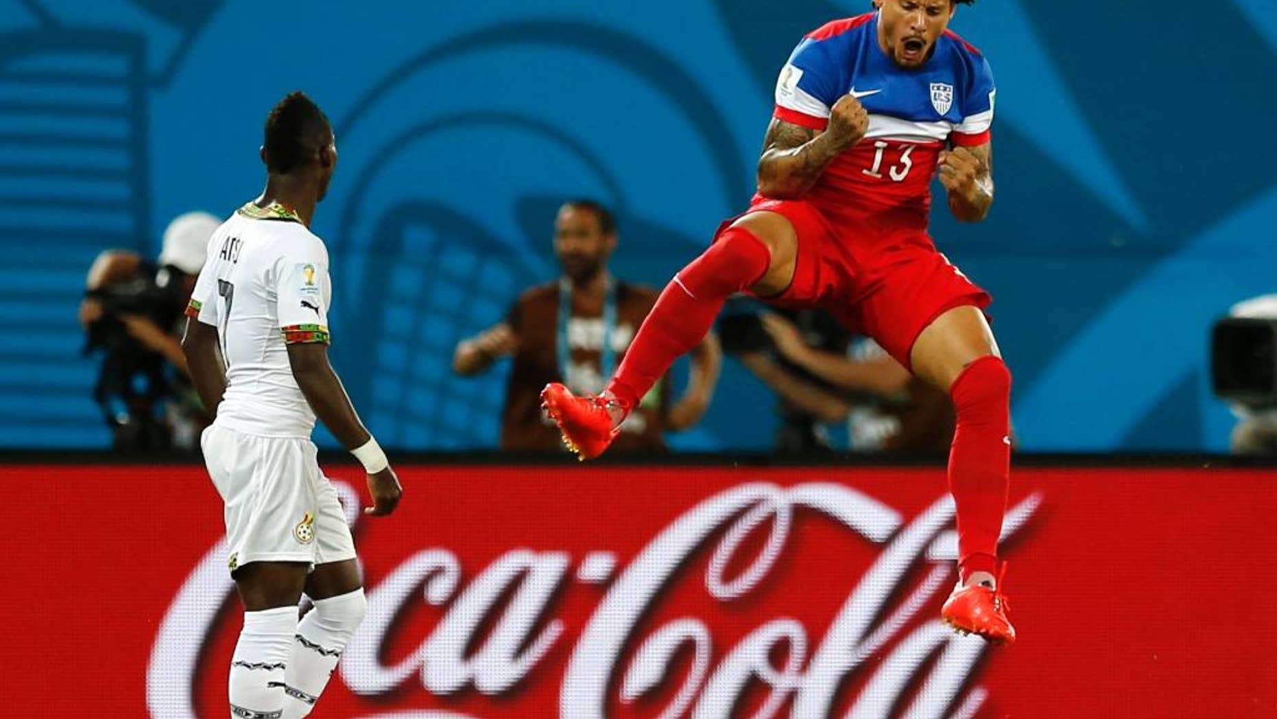 Ghana's Christian Atsu, left, looks back at his net as United States' Jermaine Jones celebrates a goal by Clint Dempsey during the group G World Cup soccer match between Ghana and the United States at the Arena das Dunas in Natal, Brazil, Monday, June 16, 2014. (AP Photo/Julio Cortez)