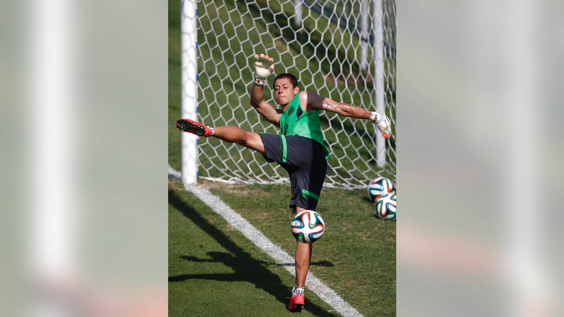 Mexico's national soccer player Javier Hernandez kicks the ball during a training session of Mexico in Santos, Brazil, Sunday, June 8, 2014. Mexico plays in group A of the 2014 soccer World Cup. (AP Photo/Eduardo Verdugo)