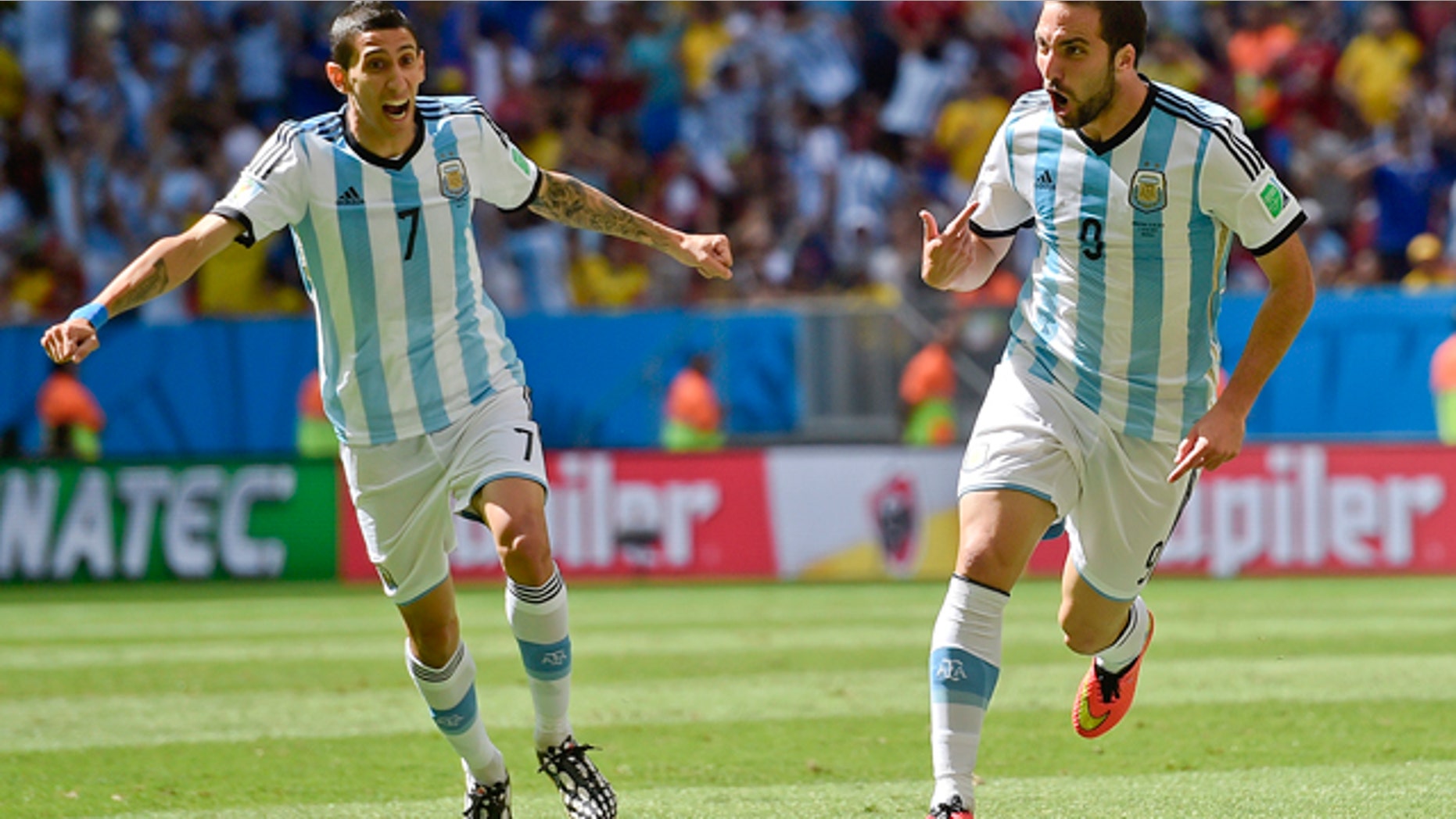 July 5, 2014: Argentina's Gonzalo Higuain, right, celebrates with Angel di Maria after scoring the opening goal during the World Cup quarterfinal soccer match between Argentina and Belgium at the Estadio Nacional in Brasilia, Brazil. (AP Photo/Martin Meissner)