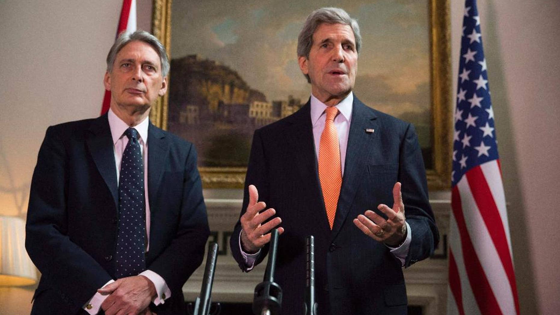 Britain's Foreign Secretary Philip Hammond and U.S. Secretary of State John Kerry, right, deliver a statement at a press conference in London, Saturday Feb, 21, 2015. US Secretary of State John Kerry, in London for talks with Foreign Secretary Philip Hammond, said Russia's conduct was "simply unacceptable" and that he expected to see agreement on further international sanctions in the coming days. "Russia has engaged in an absolutely brazen and cynical process over these last days. We know to a certainty what Russia has been providing to the separatists, how Russia is involved with the separatists," he told reporters. (AP Phto/Neil Hall/Pool)