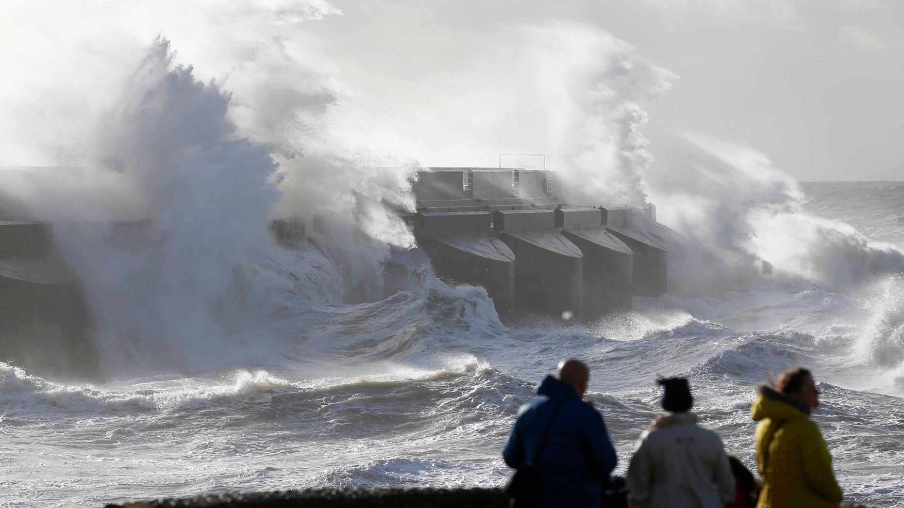 Oct. 28, 2013 - People watch waves batter the sea wall of a marina in Brighton, south England. A major storm with hurricane force winds is lashing much of Britain, causing flooding and travel delays including the cancellation of roughly 130 flights at London's Heathrow Airport.