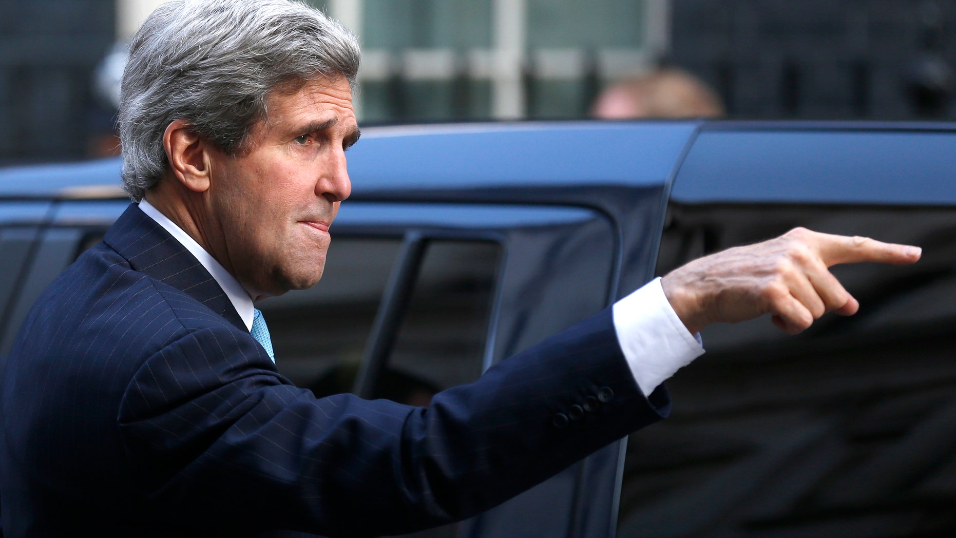 US Secretary of State John Kerry gestures as he arrives for a meeting with Britain's Prime Minister David Cameron and the Foreign Secretary William Hague at Downing street in London, Friday, March, 14, 2014. Kerry arrived in London Friday, for his last meeting with Russian Foreign Minister Sergey Lavrov before the Crimea vote. (AP Photo/Sang Tan)