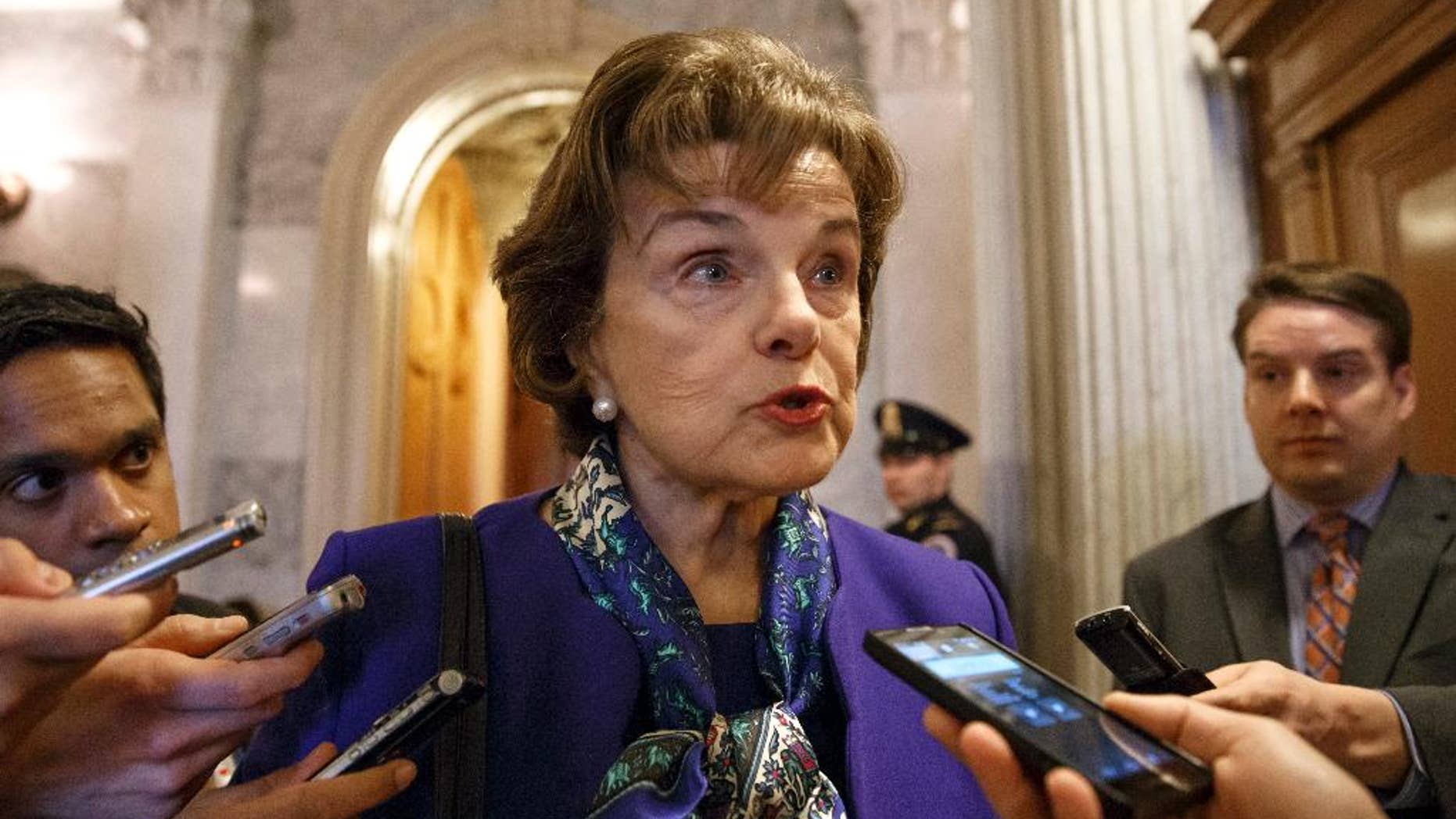 Senate Intelligence Committee Chair Sen. Dianne Feinstein, D-Calif. talks to reporters as she leaves the Senate chamber on Capitol Hill in Washington, Tuesday, March 11, 2014, after saying that the CIA's improper search of a stand-alone computer network established for Congress has been referred to the Justice Department. The issue stems from the investigation into allegations of CIA abuse in a Bush-era detention and interrogation program. (AP Photo/J. Scott Applewhite)