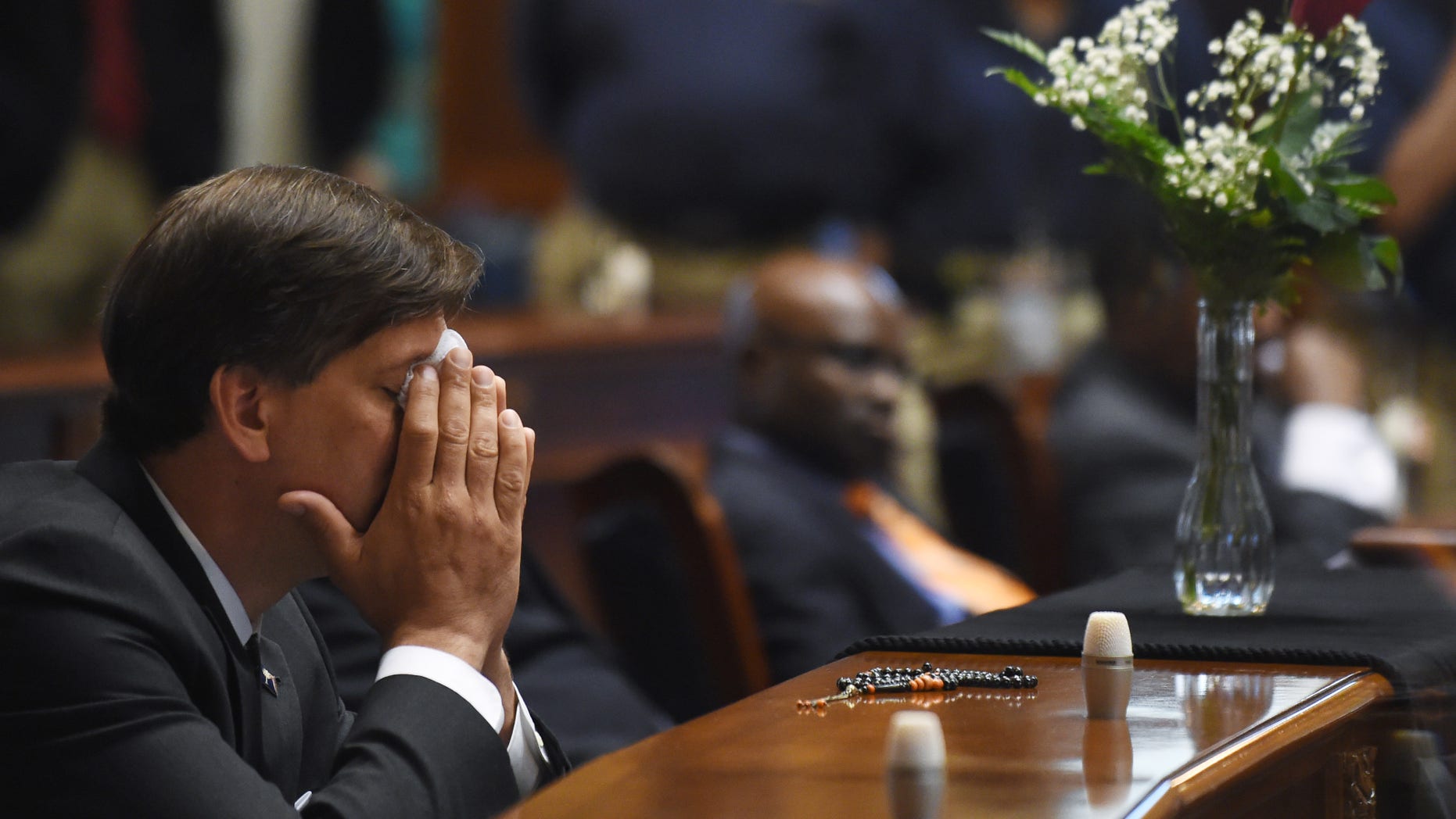 State Senator Vincent Sheheen (D-Kershaw) gets emtional as he sits next to the draped desk of state Sen. Clementa Pinckney, Thursday, June 18, 2015, at the Statehouse in Columbia, S.C. Pinckney was one of those killed, Wednesday night in a shooting at the Emanuel AME Church in Charleston. (AP Photo/Rainier Ehrhardt)