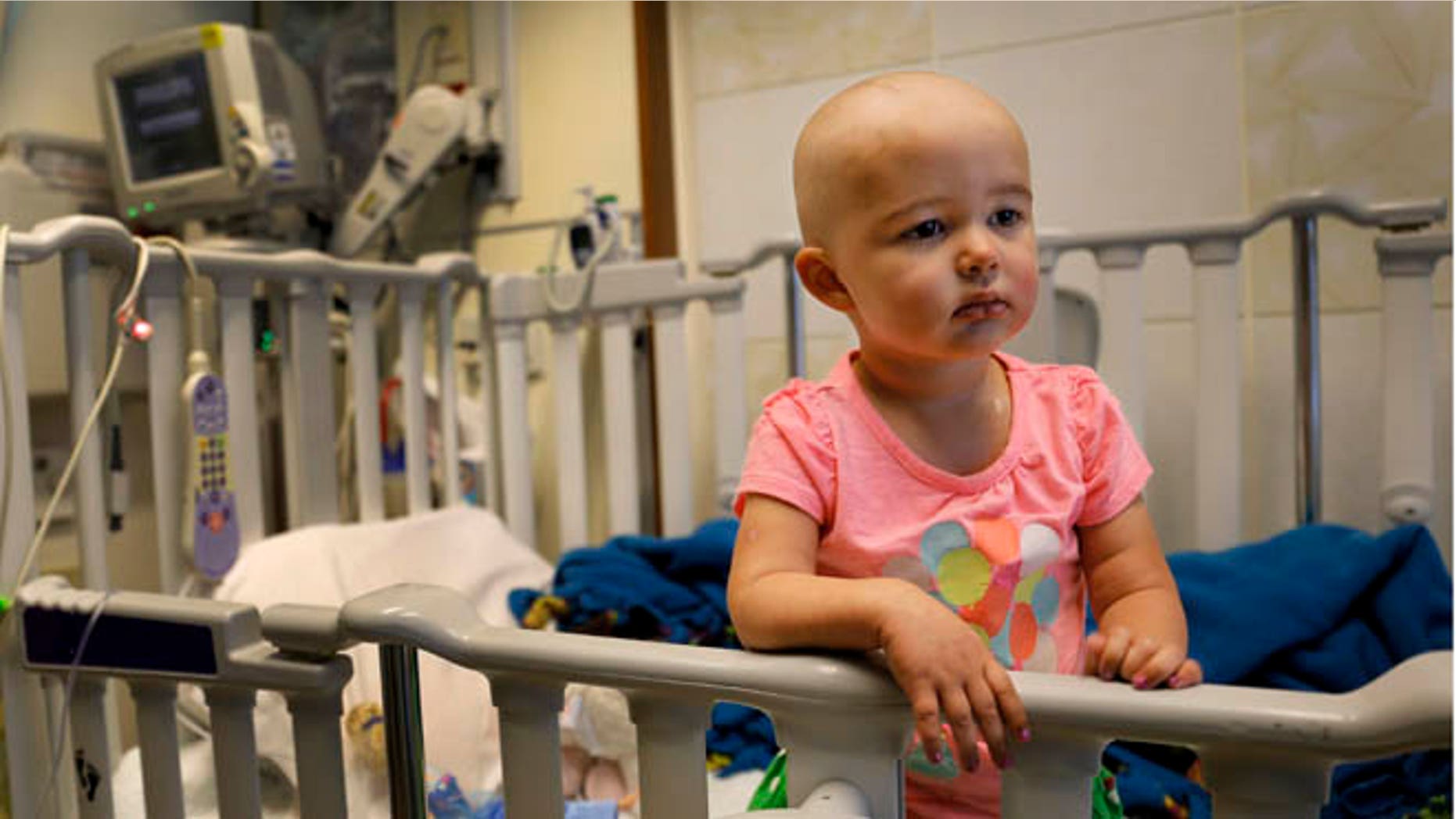 In this June 11, 2015 photo,Talia Pisano stands in her bed at Lurie Children's Hospital in Chicago. Talia is getting tough treatment for kidney cancer that spread to her brain. She's also getting a chance at having babies of her own someday. To battle infertility sometimes caused by cancer treatment, some childrenâs hospitals are trying a futuristic approach: removing and freezing immature ovary and testes tissue, with hopes of being able to put it back when patients reach adulthood and want to start families. (AP Photo/Christian K. Lee)