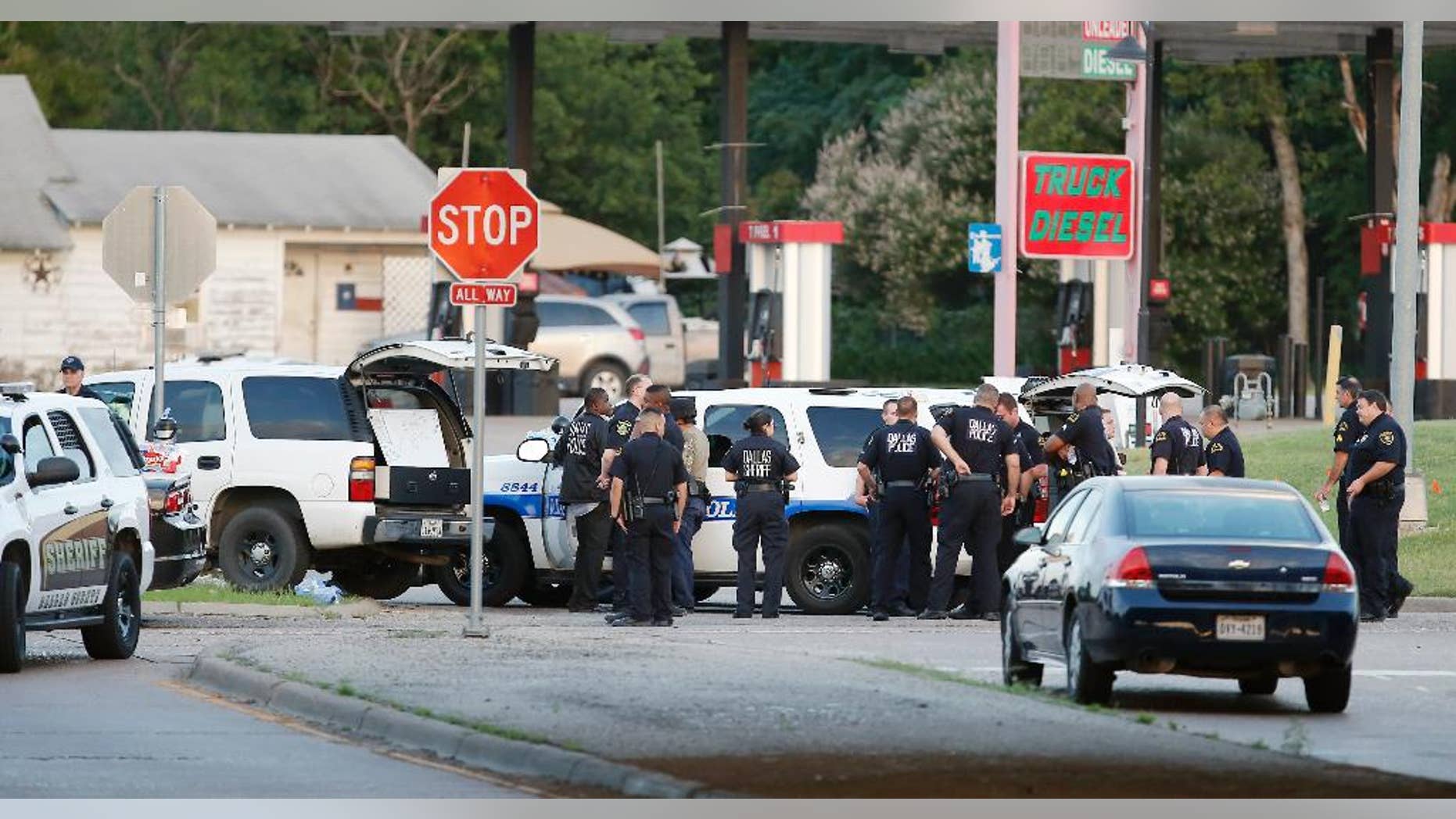 Police block the intersection of Dowdy Ferry Rd and Interstate 45 during a stand off with a gunman barricaded inside a van, Saturday, June 13, 2015, in Hutchins, Texas. The gunman allegedly attacked Dallas Police Headquarters. (AP Photo/Brandon Wade)