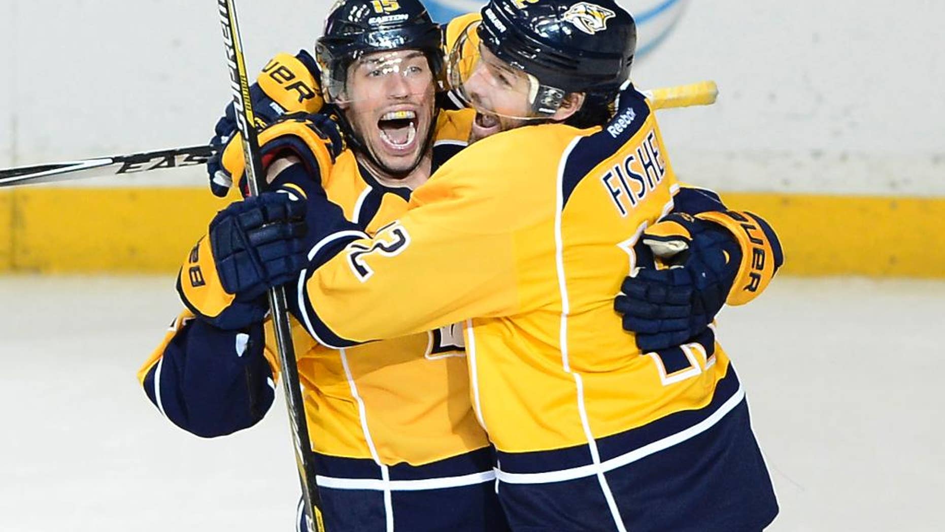 Nashville Predators center Craig Smith, left, celebrates with forward Mike Fisher (12) after Smith scored a goal in the third period of an NHL hockey game against the New Jersey Devils, Saturday, Feb. 14, 2015, in Nashville, Tenn. The Predators won 3-1. (AP Photo/Mark Zaleski)