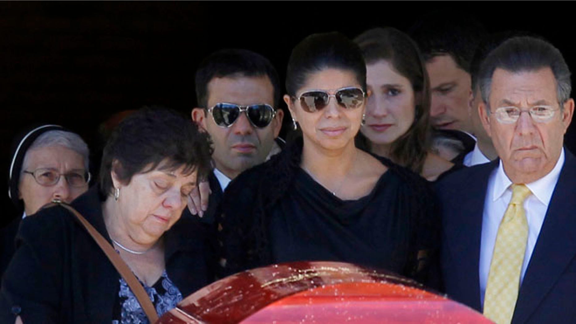 Aug. 29, 2012: Ivette Rivera, center, fiancee of Empire State Building shooting victim Steve Ercolino, is flanked by the victim's parents, Rosalie and Frank Ercolino, as they follow the coffin out after a funeral mass at Our Lady of Sorrows church in White Plains, N.Y.