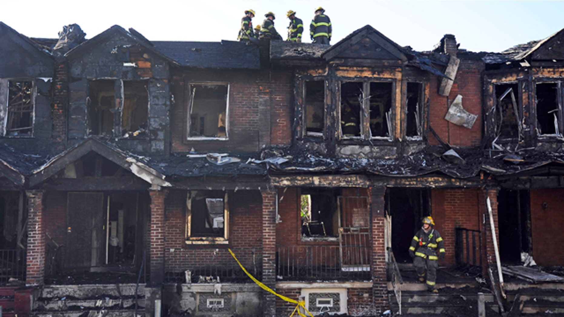 July 5, 2014: Philadelphia firefighters work on burned row homes. (AP Photo/Michael Perez)