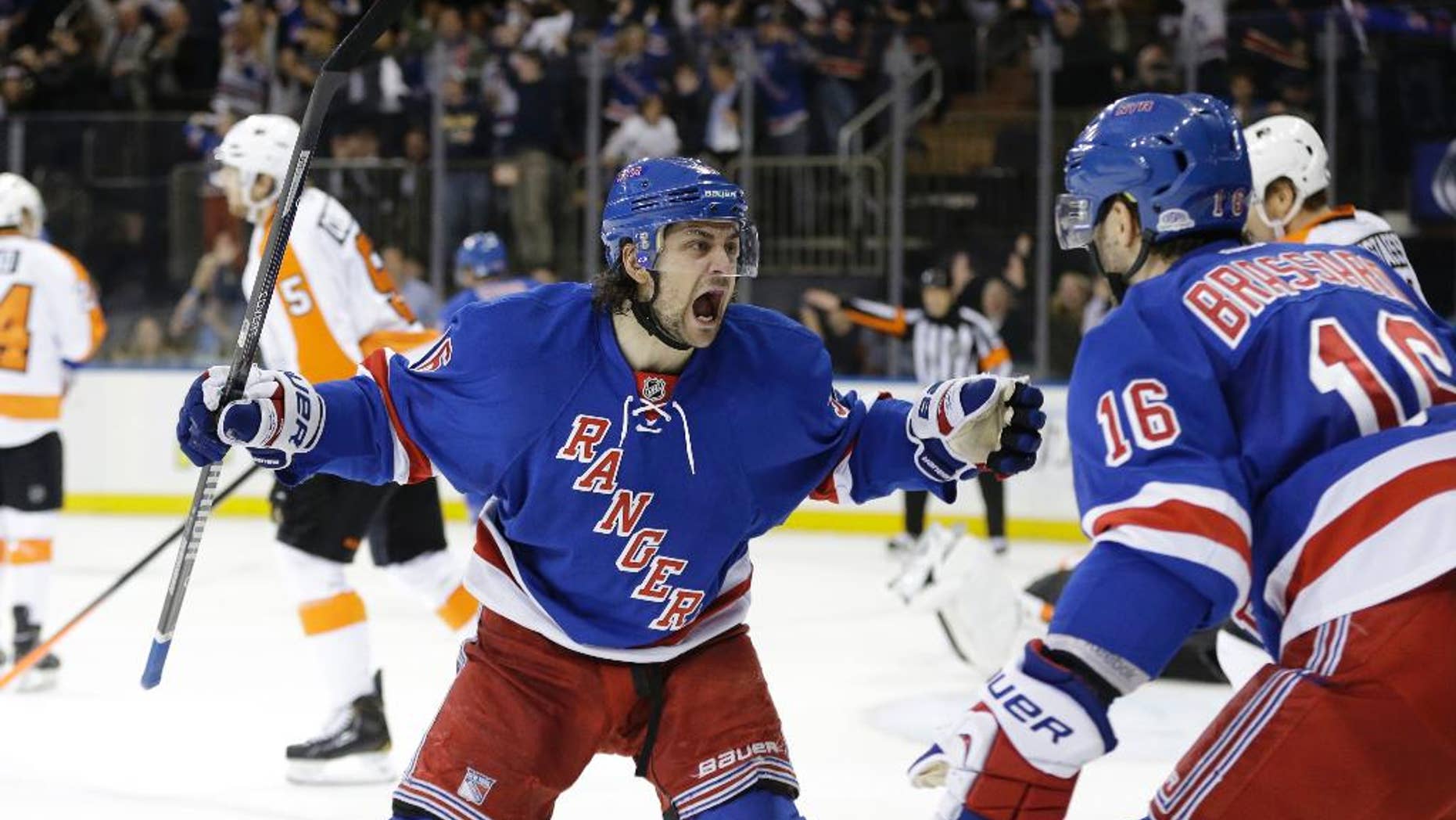 New York Rangers' Mats Zuccarello (36) and Derick Brassard (16) celebrate a goal by Benoit Pouliot during the second period in Game 7 of an NHL hockey first-round playoff series against the Philadelphia Flyers, Wednesday, April 30, 2014, in New York. (AP Photo)