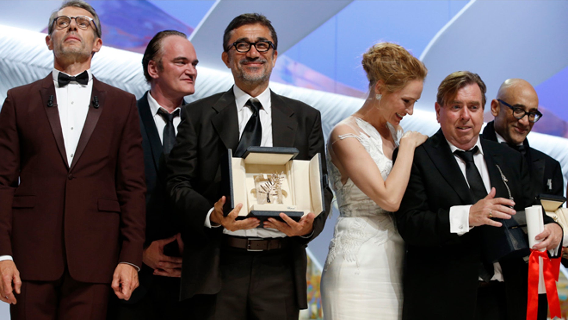 May 24, 2014: Director Nuri Bilge Ceylan, center, poses with the Palme d'Or award for the film Winter Sleep and actor Timothy Spall, second right, poses with his award for Best Actor for his role in the film Mr. Turner during the awards ceremony for the 67th international film festival, Cannes, southern France. (AP)