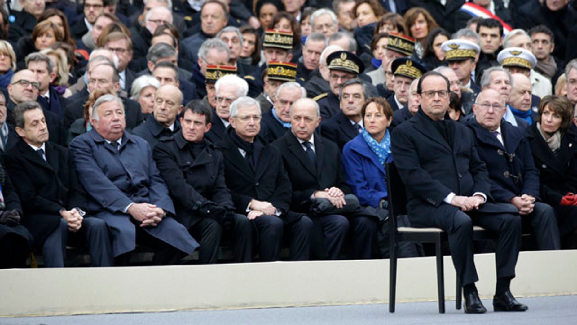 Nov. 27, 2015: French President Francois Hollande, right, attends a ceremony to honor the 130 victims killed in the Nov. 13 attacks, in the courtyard of the Invalides in Paris. (Philippe Wojazer/Pool Photo via AP)