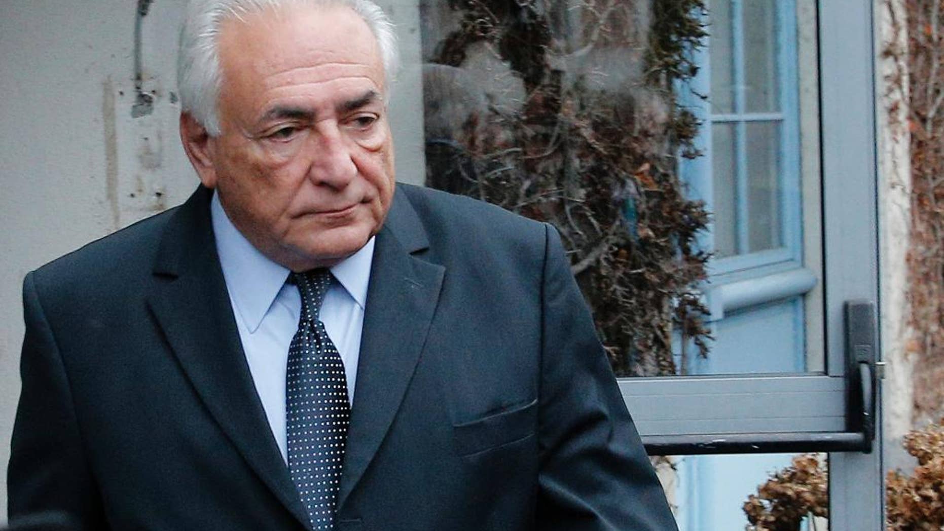 Former International Monetary Fund boss Dominique Strauss-Kahn leaves his hotel in Lille, northern France, Wednesday, Feb. 11, 2015 as he goes on trial for sex charges at a court. Strauss-Kahn sat nonchalantly with folded-arms and stretched legs Tuesday, before telling a French court he was completely unaware that women who participated in orgies at luxury hotels in Paris and Washington were prostitutes. (AP Photo/Christophe Ena)