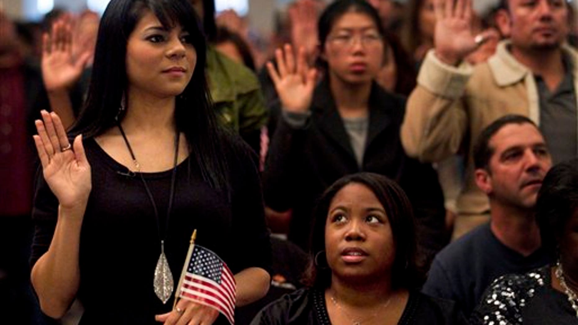 Dec. 15: Shyima Hall, left, takes the oath of citizenship during a citizenship ceremony in Montebello, Calif.