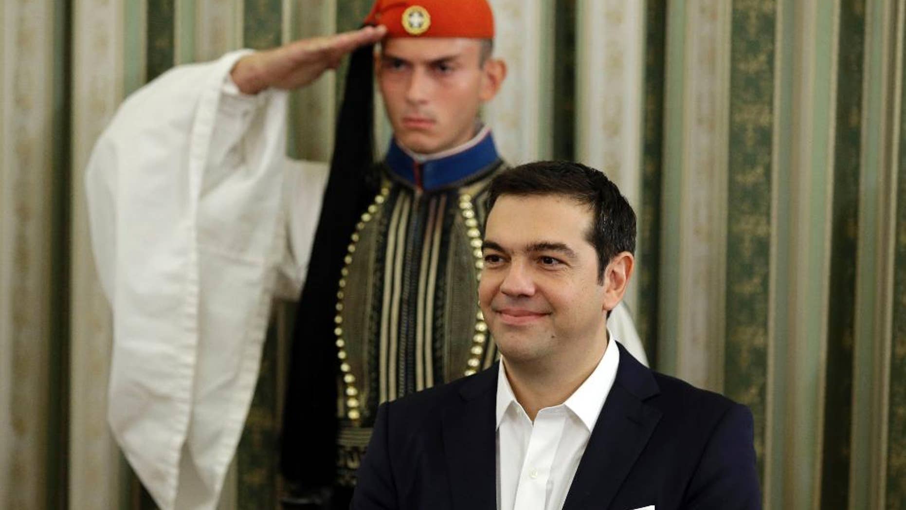Greece's Prime Minister Alexis Tsipras attends his cabinet's swearing in ceremony at the presidential palace in Athens, Wednesday, Sept. 23, 2015. Despite leftwing leader Alexis Tsipras' policy U-turn, he was re-elected by a wide margin in last weekend's general election, and again formed a coalition government with a small right-wing party, the Independent Greeks. (AP Photo/Thanassis Stavrakis)