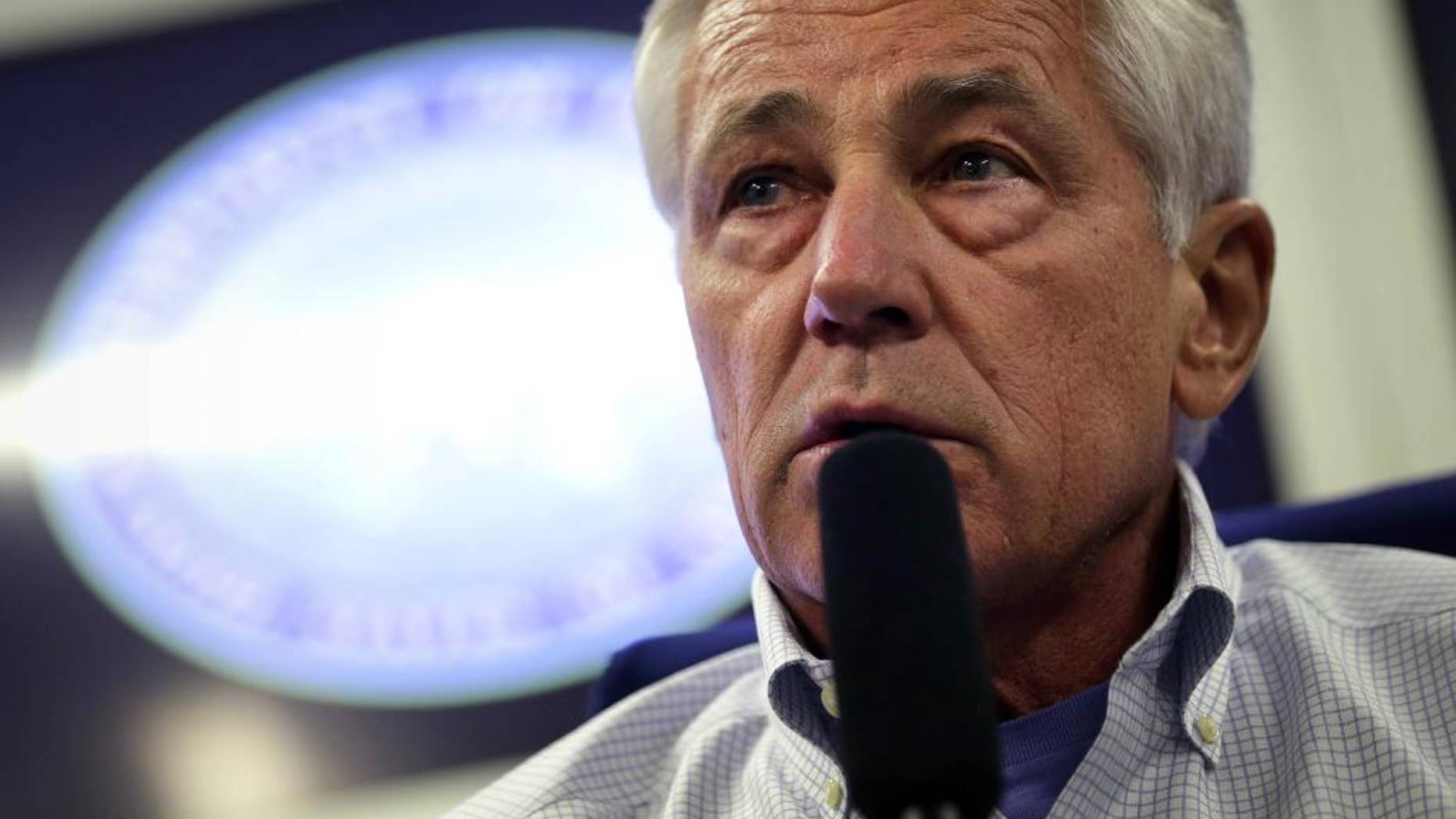 U.S. Defense Secretary Chuck Hagel speaks to members of a travel press pool, Friday, April 4, 2014, in flight, while en route to Tokyo, from Honolulu. Hagel is traveling to Japan, China and Mongolia. (AP Photo/Alex Wong, Pool)