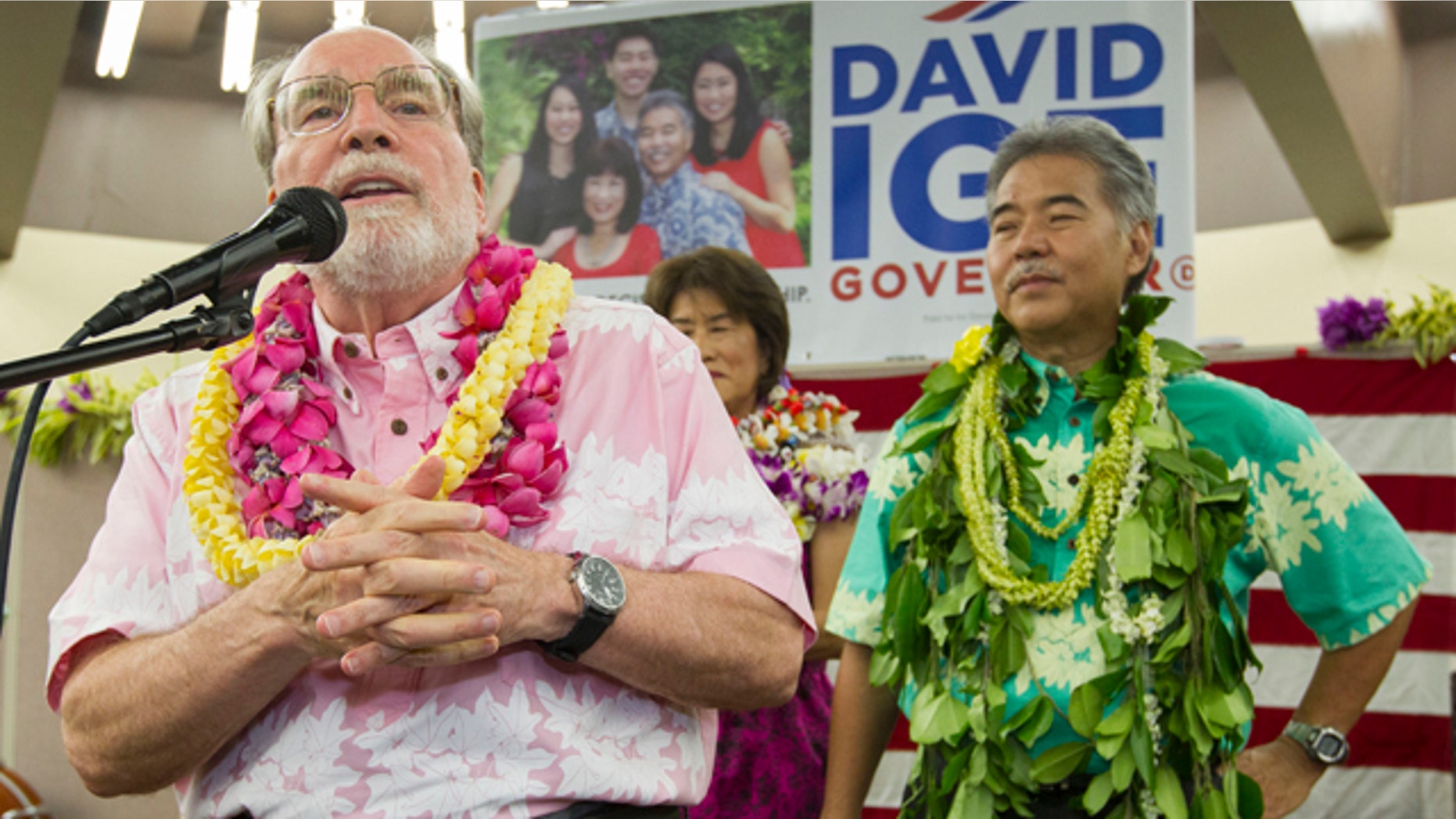Saturday 9, 2014: Hawaii Governor Neil Abercrombie, left, addresses the supporters of Hawaii State Sen. David Ige as Ige, right, looks on. Ige defeated Abercrombie in the state's primary election to win the Democratic Party's nomination. (AP Photo/Eugene Tanner)
