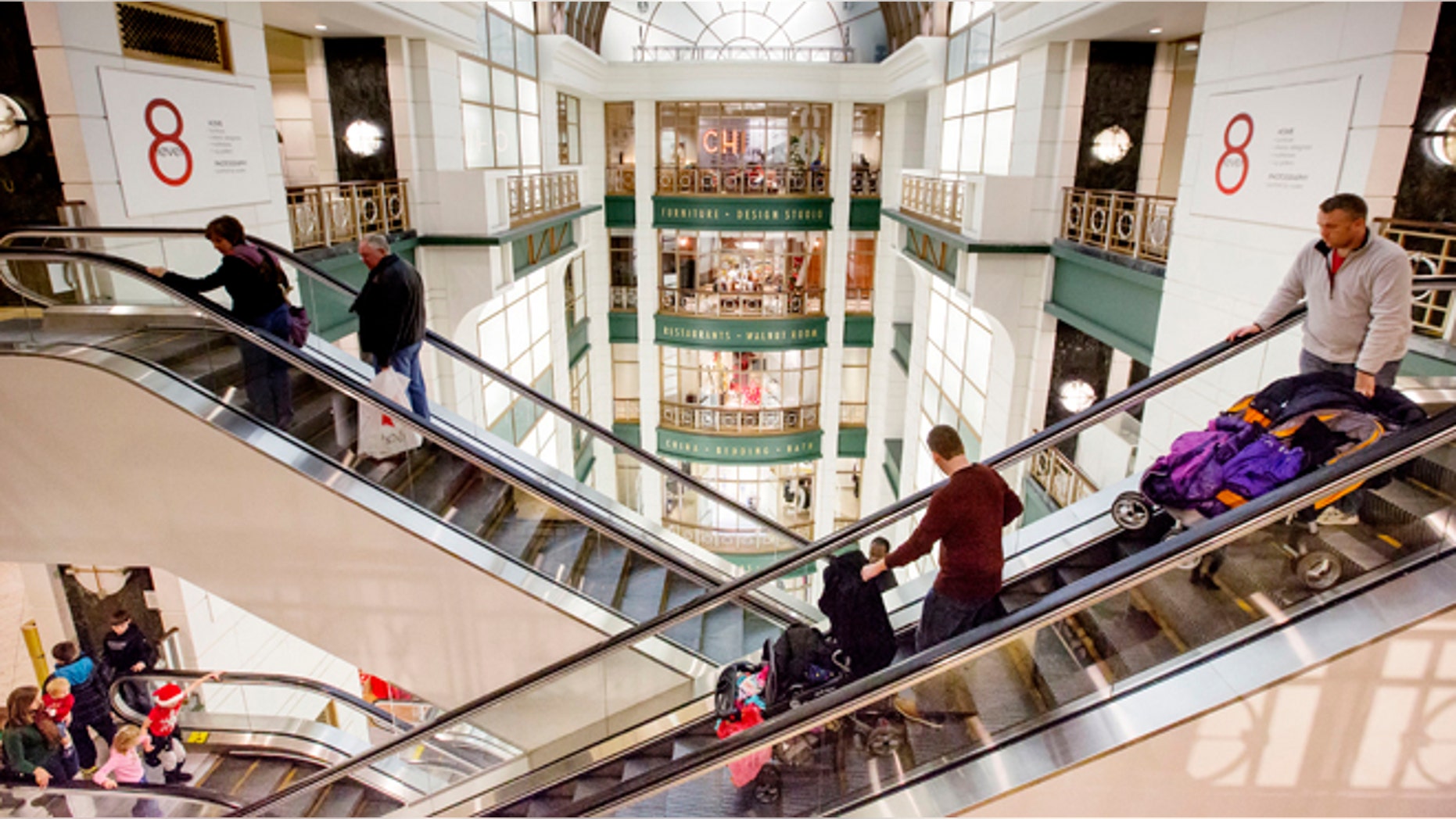 Shoppers ride escalators between floors during Black Friday shopping at Macy's on Friday, Nov. 29, 2013, in Chicago.