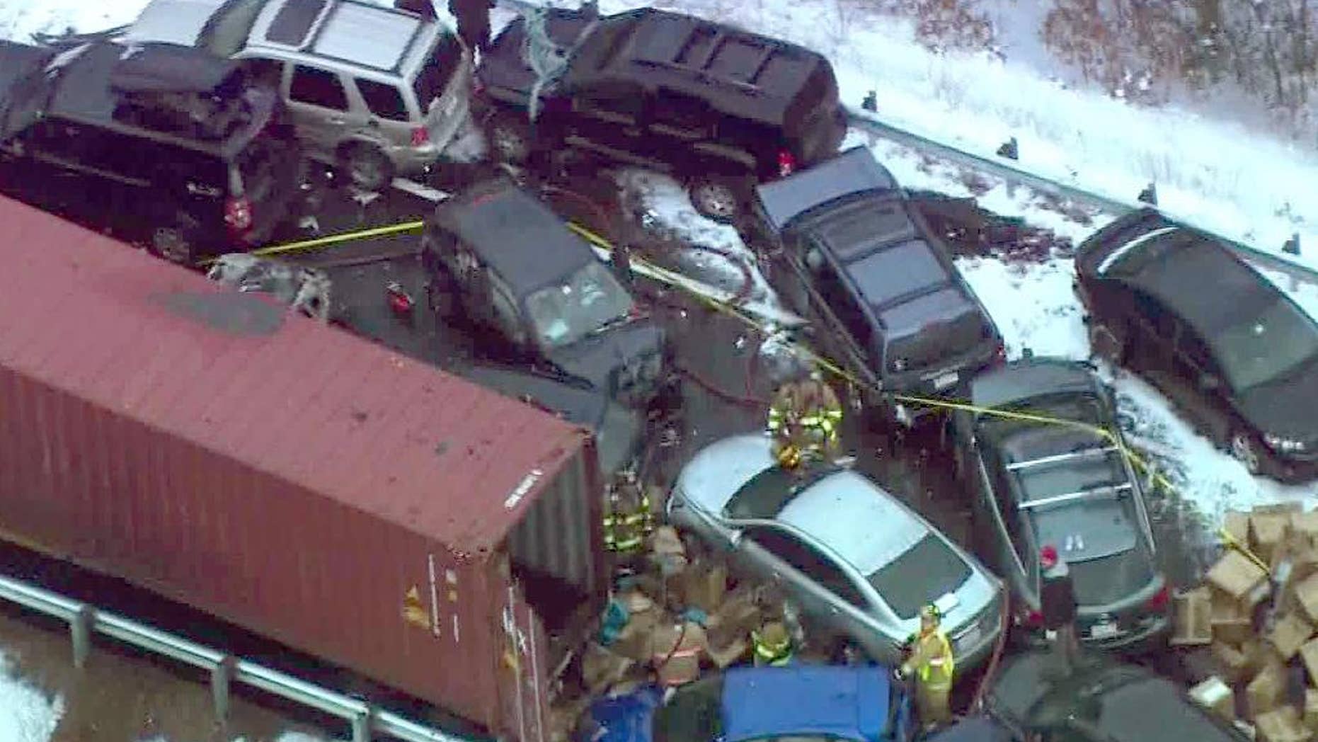 In this frame grab made from aerial video provided by WCVB-TV, emergency personnel work the scene along Interstate Route 93 near Ashland, N.H., where a New Hampshire State Police spokesman says 35 vehicles were involved in two separate pileups after some fast-moving snow squalls, Friday, Jan. 2, 2015. (AP Photo/WCVB-TV)