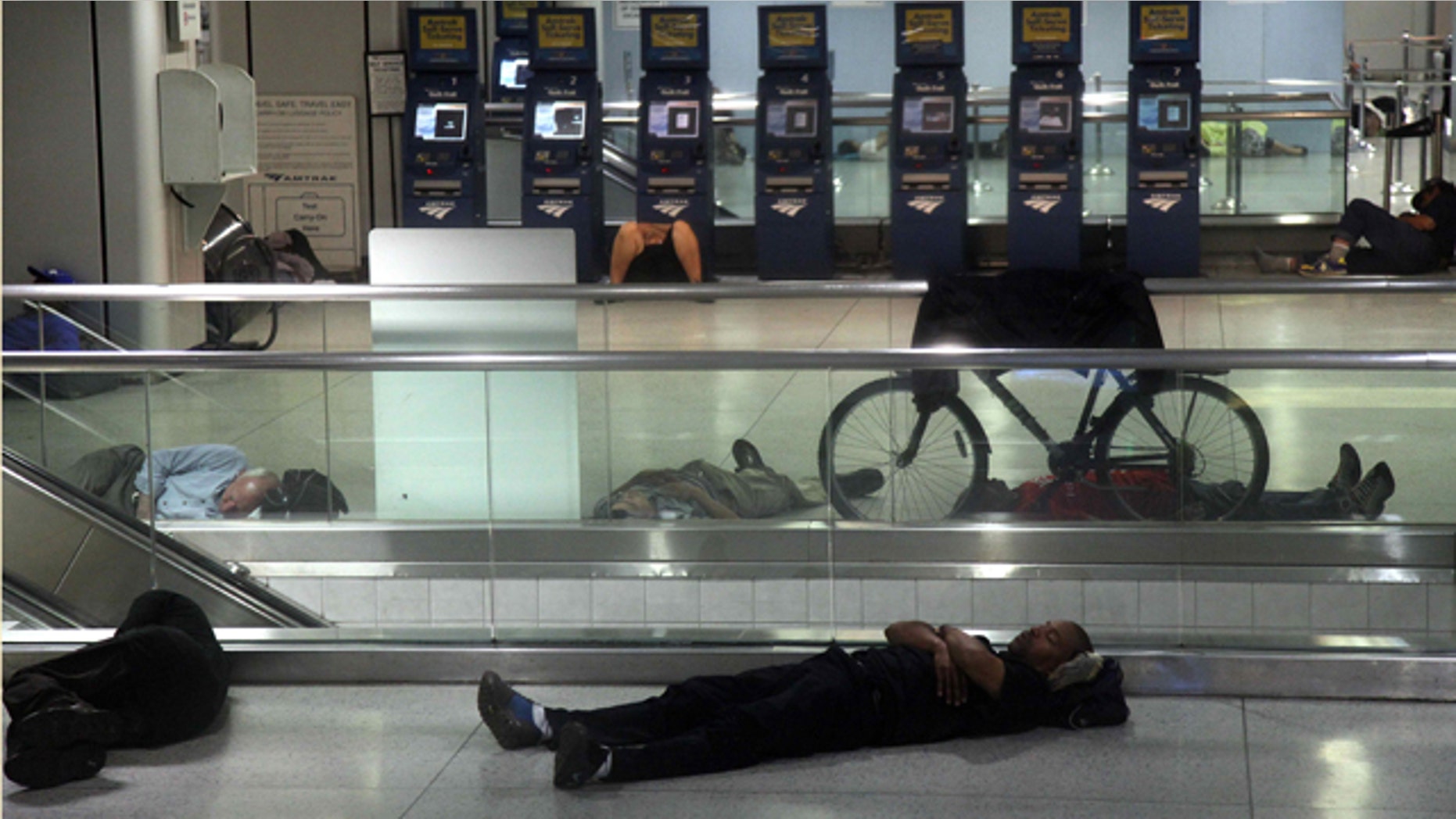People sleep at Penn Station in New York, early Sunday, Aug. 28, 2011, as Hurricane Irene approaches the region. Public transportation in New York shut down around noon on Saturday. Irene has the potential to cause billions of dollars in damage all along a densely populated arc that includes Washington, Baltimore, Philadelphia, New York, Boston and beyond. At least 65 million people could be affected. (AP Photo/Chelsea Matiash)