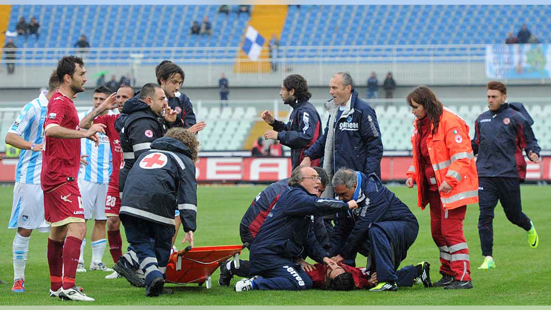 April 14, 2012: Medics assists Livorno's Piermario Morosini laying on the turf of the Pescara's Adriatico stadium, central Italy, Saturday, after he collapsed during a Serie B soccer match between Pescara and Livorno.