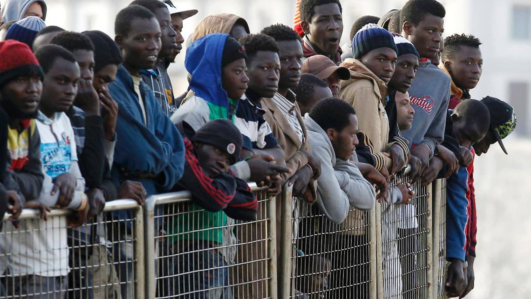 Migrants wait to disembark from the Iceland Coast Guard vessel Tyr, at the Messina harbor, Sicily, southern Italy, Wednesday, May 6, 2015. This weekend saw a dramatic increase in rescues as smugglers in Libya took advantage of calm seas and warm weather to send thousands of would-be refugees out into the Mediterranean in overloaded rubber boats and fishing vessels. (AP Photo/Antonio Calanni)