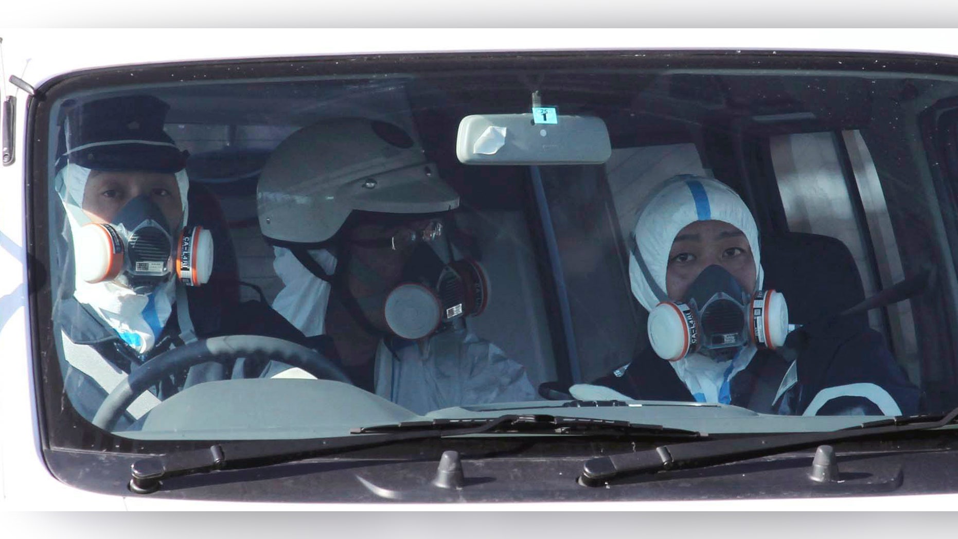 March 12: Police officers wearing gas masks patrol in the area of the Fukushima power plant's Unit 1 in Okumamachi, Fukushima Prefecture, northern Japan, amid fears that a part of the plant could meltdown after being hit by a powerful earthquake and tsunami Friday. (AP/The Yomiuri Shimbun)