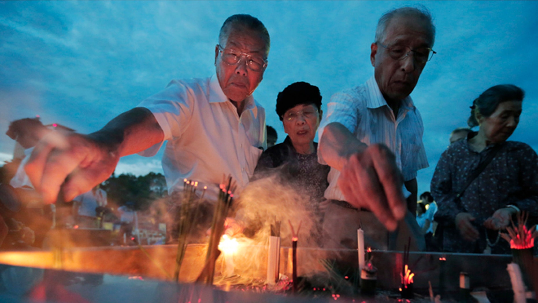 Aug. 6, 2012: People burn incenses and pray in front of the cenotaph dedicated to the victims of the atomic bombing at the Peace Memorial Park as they mark the 67th anniversary of the world's first atomic bombing, in Hiroshima, western Japan.