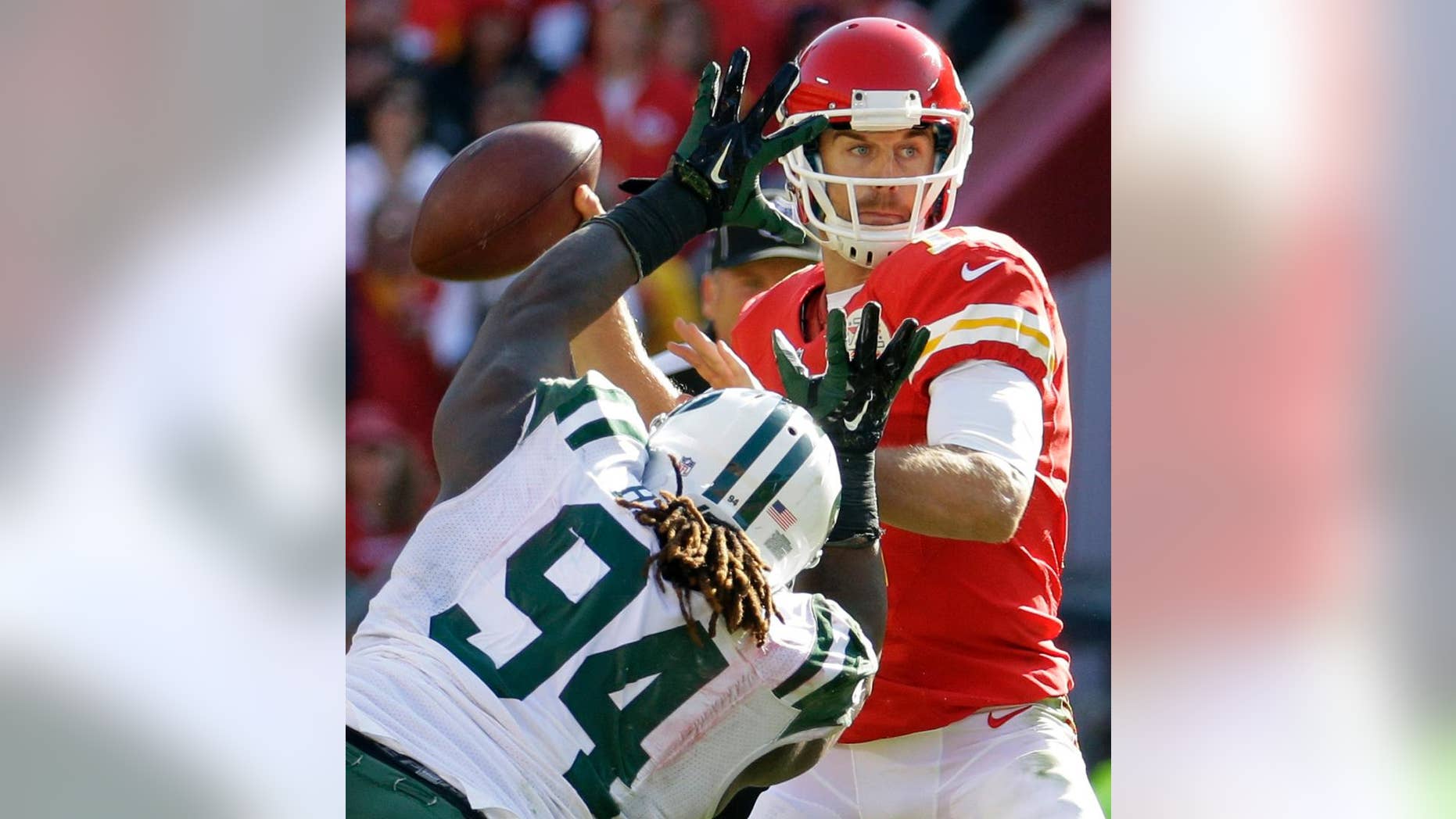 Kansas City Chiefs quarterback Alex Smith (11) throws under pressure from New York Jets nose tackle Damon Harrison (94) in the second half of an NFL football game in Kansas City, Mo., Sunday, Nov. 2, 2014. (AP Photo/Charlie Riedel)