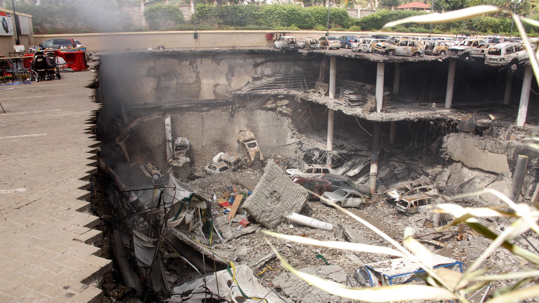 Sept. 26, 2013 - Collapsed upper car park of the Westgate Mall in Nairobi, Kenya. Working near bodies crushed by rubble in a bullet-scarred, scorched mall, FBI agents continued fingerprint, DNA and ballistic analysis to help determine the identities and nationalities of victims and al-Shabab gunmen who attacked the shopping center, killing more than 60 people. Photo released by Kenya Presidency.
