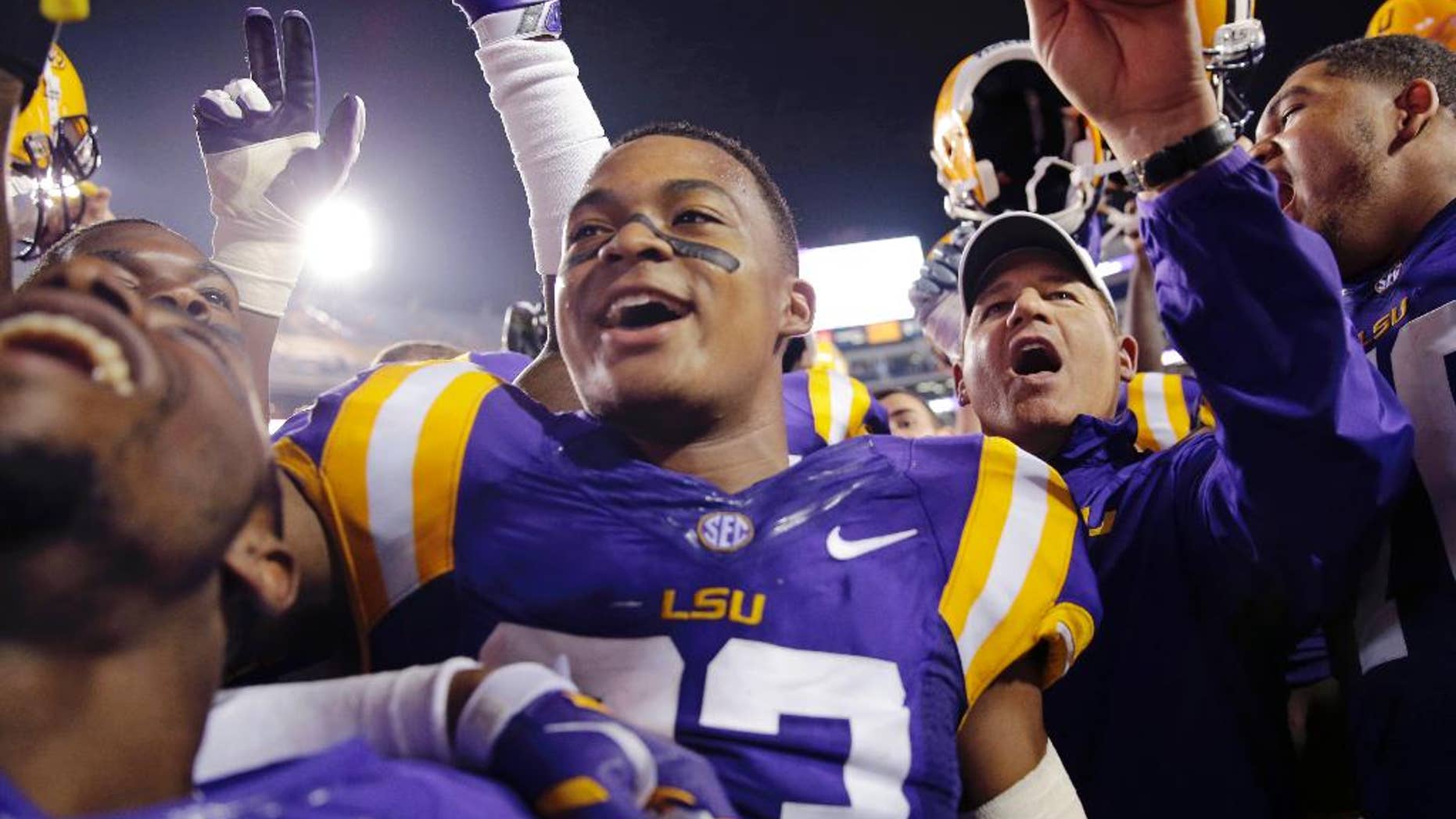 LSU coach Les Miles, right, sings the school alma mater with his team after an NCAA college football game against Louisiana-Monroe in Baton Rouge, La., Saturday, Sept. 13, 2014. LSU won 31-0. (AP Photo/Gerald Herbert)