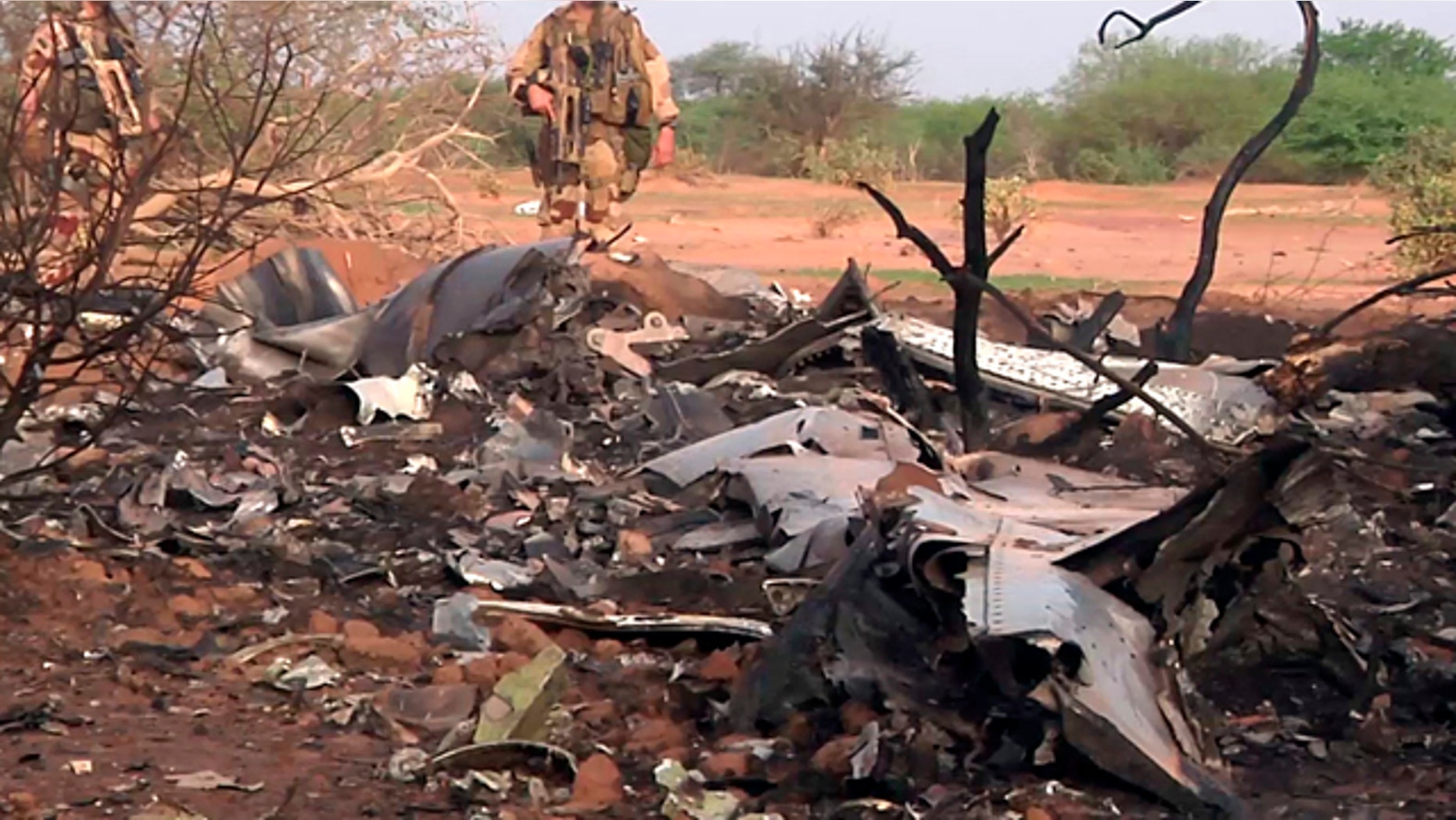 July 25, 2014: This photo provided by the French army shows soldiers at the site of the plane crash in Mali. (AP Photo/ECPAD)