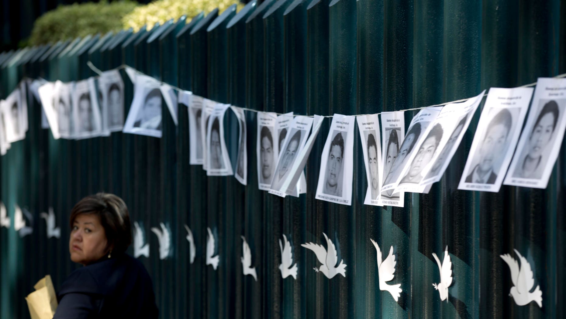 Images of the 43 students missing strung on the front gate of the Mexican attorney general's office in Mexico City.
