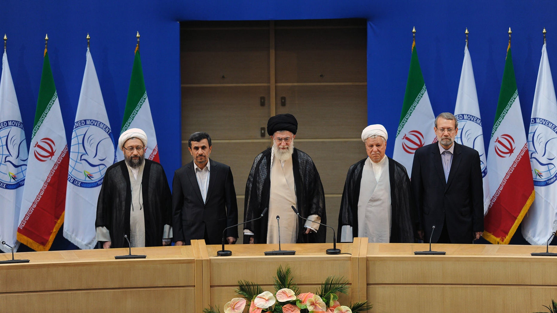 In this photo released by the official website of the Iranian supreme leader's office, supreme leader Ayatollah Ali Khamenei, center, parliament speaker Ali Larijani, right, chief of Expediency Council, Akbar Hashemi Rafsanjani, second right, President Mahmoud Ahmadinejad, second left, and judiciary chief Sadeq Larijani, left, listen to Iran's national anthem, at the opening session of the Nonaligned Movement, NAM, summit, in Tehran, Iran, Thursday, Aug. 30, 2012. (AP Photo/Office of the Supreme Leader)