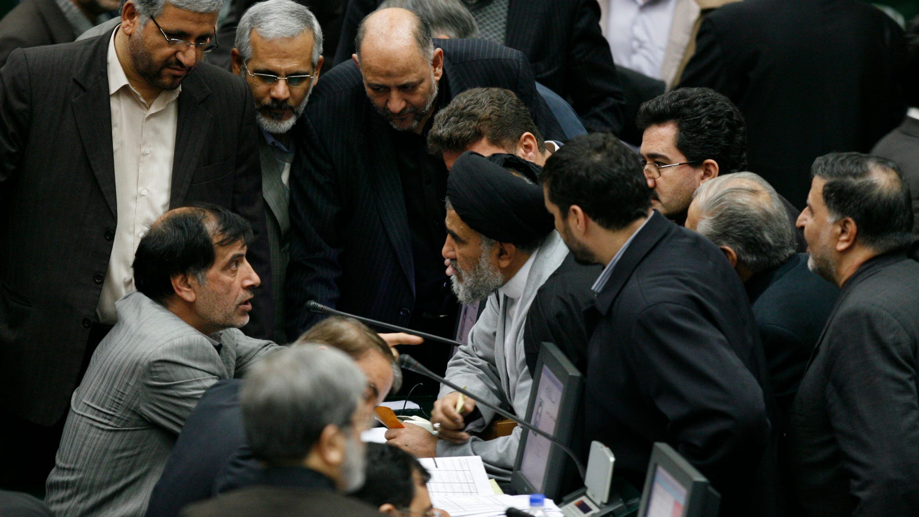 Feb. 1: Iranian lawmakers talk in an open session of parliament to debate on impeachment of Transportation Minister Hamid Behbahani, unseen, in Tehran, Iran.