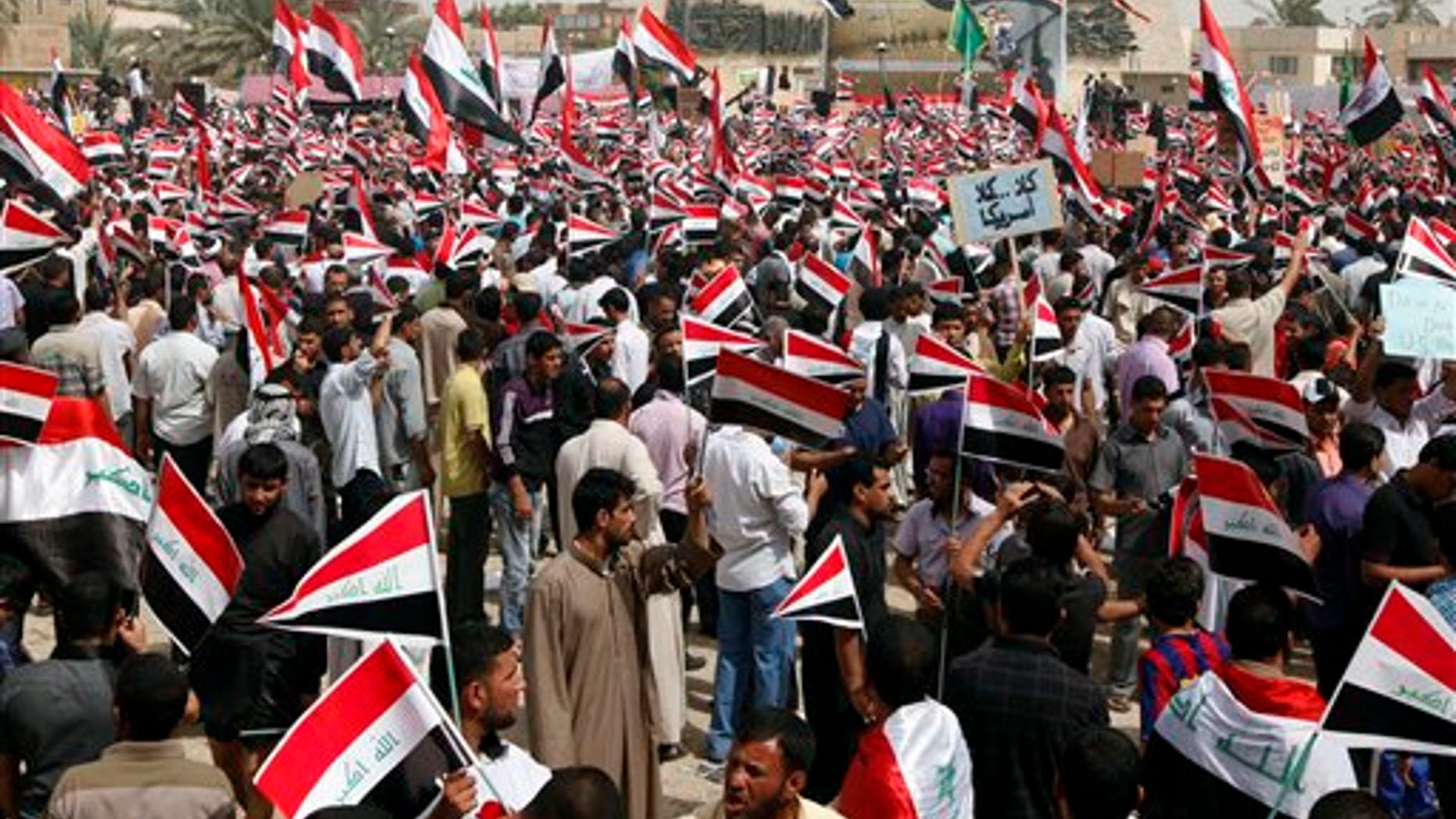 April 9: Followers of radical Shiite cleric Muqtada al-Sadr wave Iraqi flags during a rally marking the eighth anniversary of the fall of the Iraqi capital to American troops in Baghdad, Iraq. A powerful anti-American Shiite cleric has threatened to reactivate his feared militia in Iraq if U.S. soldiers extend their stay. (AP)