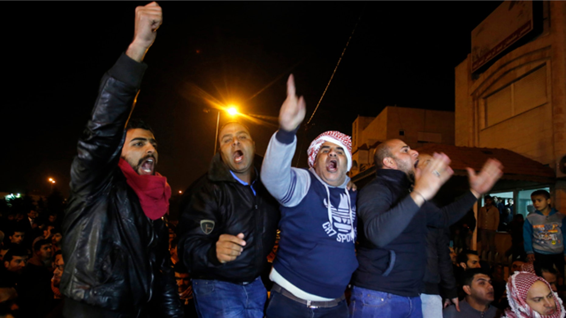 Feb. 3, 2015: Supporters and family members of Jordanian pilot Lt. Muath al-Kaseasbeh express their anger of his reported killing outside the tribal gathering chamber in Amman, Jordan. (AP Photo/Raad Adayleh)