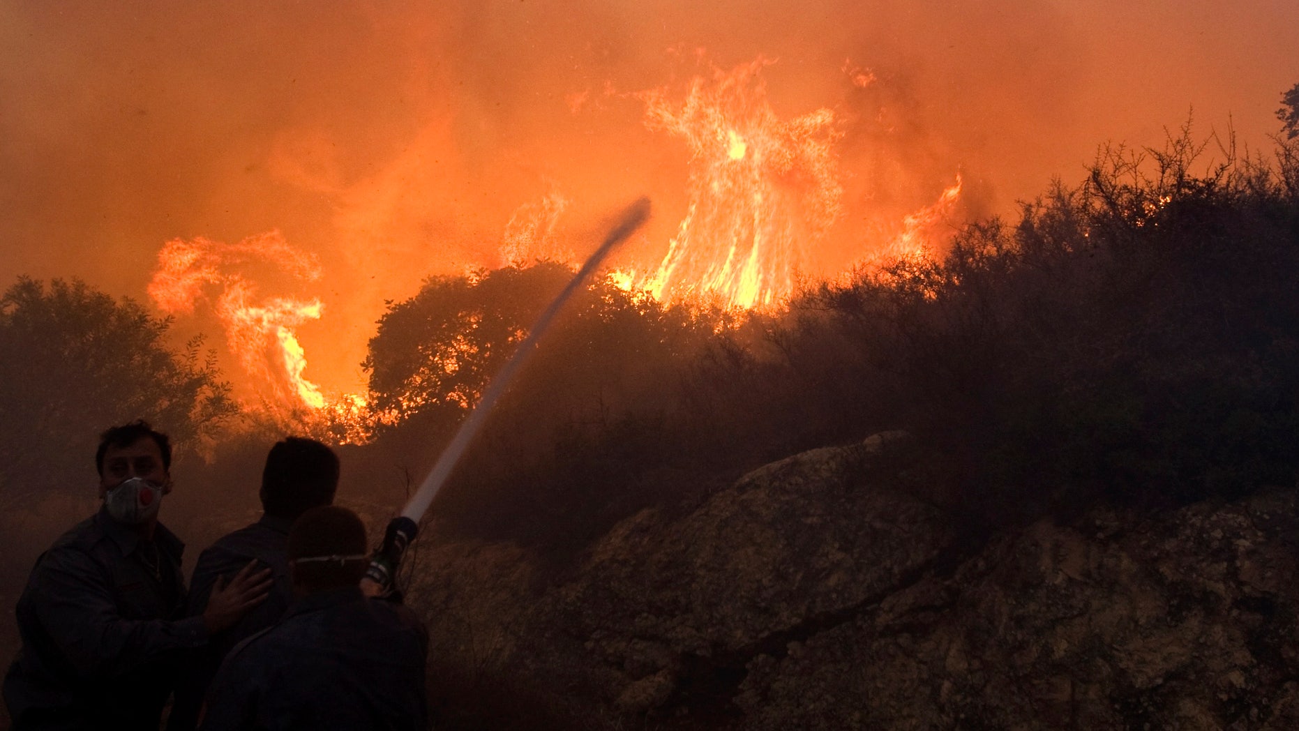 Dec. 3: Firefighters try to extinguish the flames in Tirat Hacarmel, northern Israel.