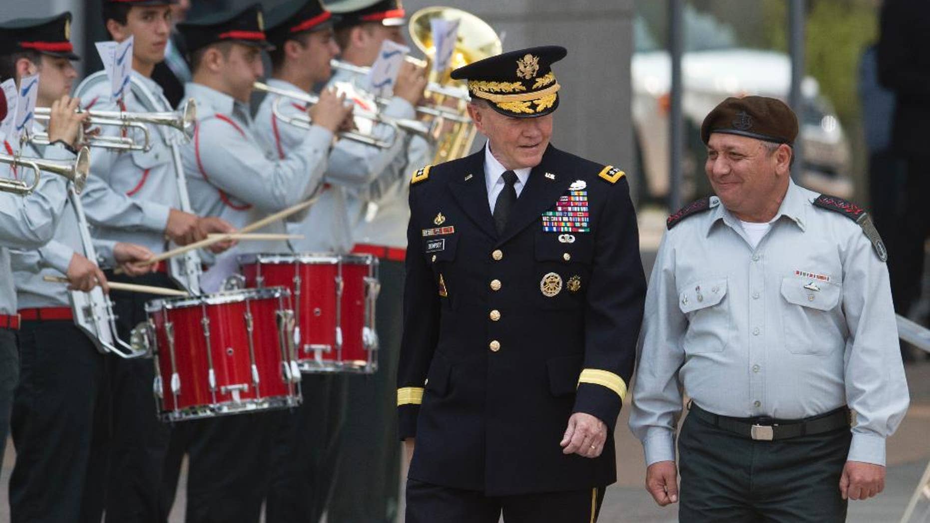 Outgoing Joint Chiefs Chairman Gen. Martin Dempsey, left, and Israeli Chief of Staff Lt. Gen. Gadi Eizenkot review an honor guard during a welcoming ceremony in a military base in Tel Aviv, Israel, Tuesday, June 9, 2015. The Chairman of the U.S. Joint Chiefs of Staff General Martin E. Dempsey landed on Monday evening in Israel for an official visit. (AP Photo/Ariel Schalit)