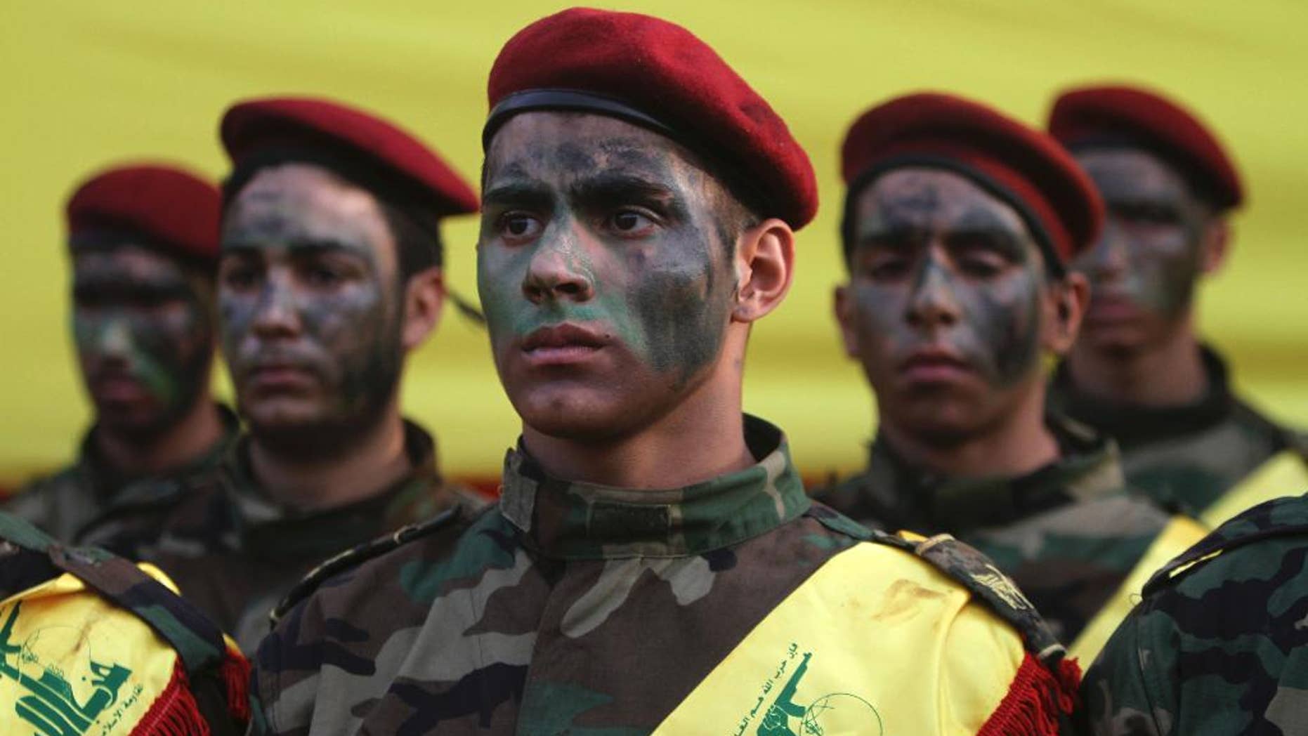 Hezbollah fighters stand by the coffin of senior Hezbollah commander Hassan Hussein al-Haj during his funeral procession in the southern Lebanese village of Loueizeh, Lebanon, Monday, Oct. 12, 2015. Local media said al-Haj was killed in the northwestern province of Idlib where Syrian government forces and Hezbollah fighters have launched an offensive against insurgents under the cover of Russian airstrikes. (AP Photo/Mohammed Zaatari)