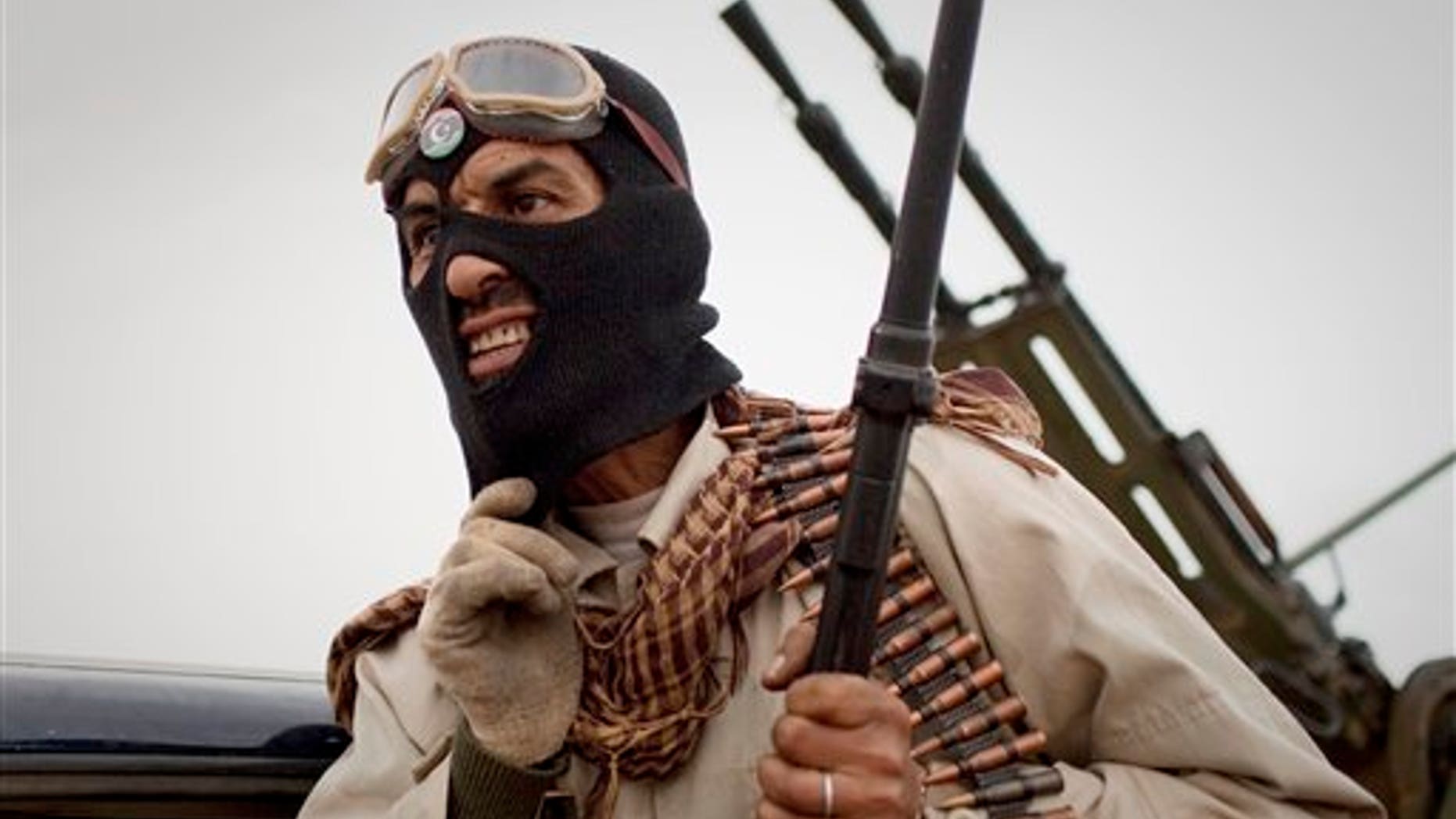 March 18: A Libyan rebel grimaces on the frontline near Sultan, south of Benghazi. (AP)
