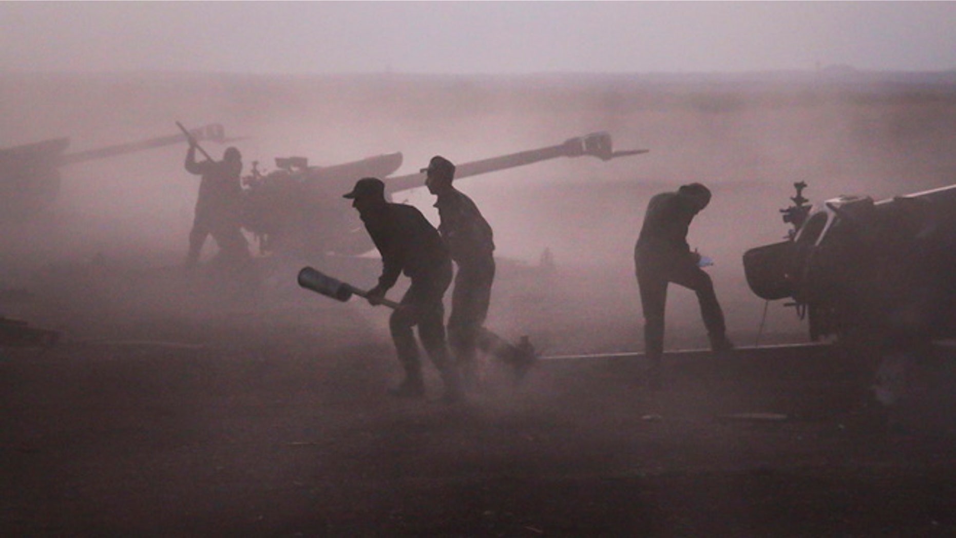 Oct. 7, 2015: Syrian army personnel load howitzers near the village of Morek in Syria.