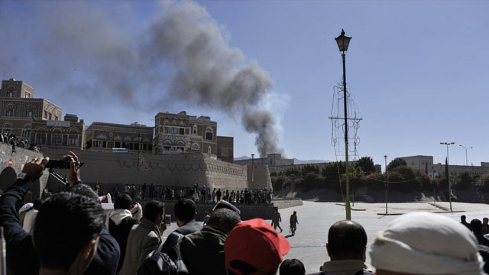 December 5, 2013: Smoke rises after an explosion at the Defense Ministry complex in Sanaa, Yemen. (AP Photo/Mohammed Hamoud)