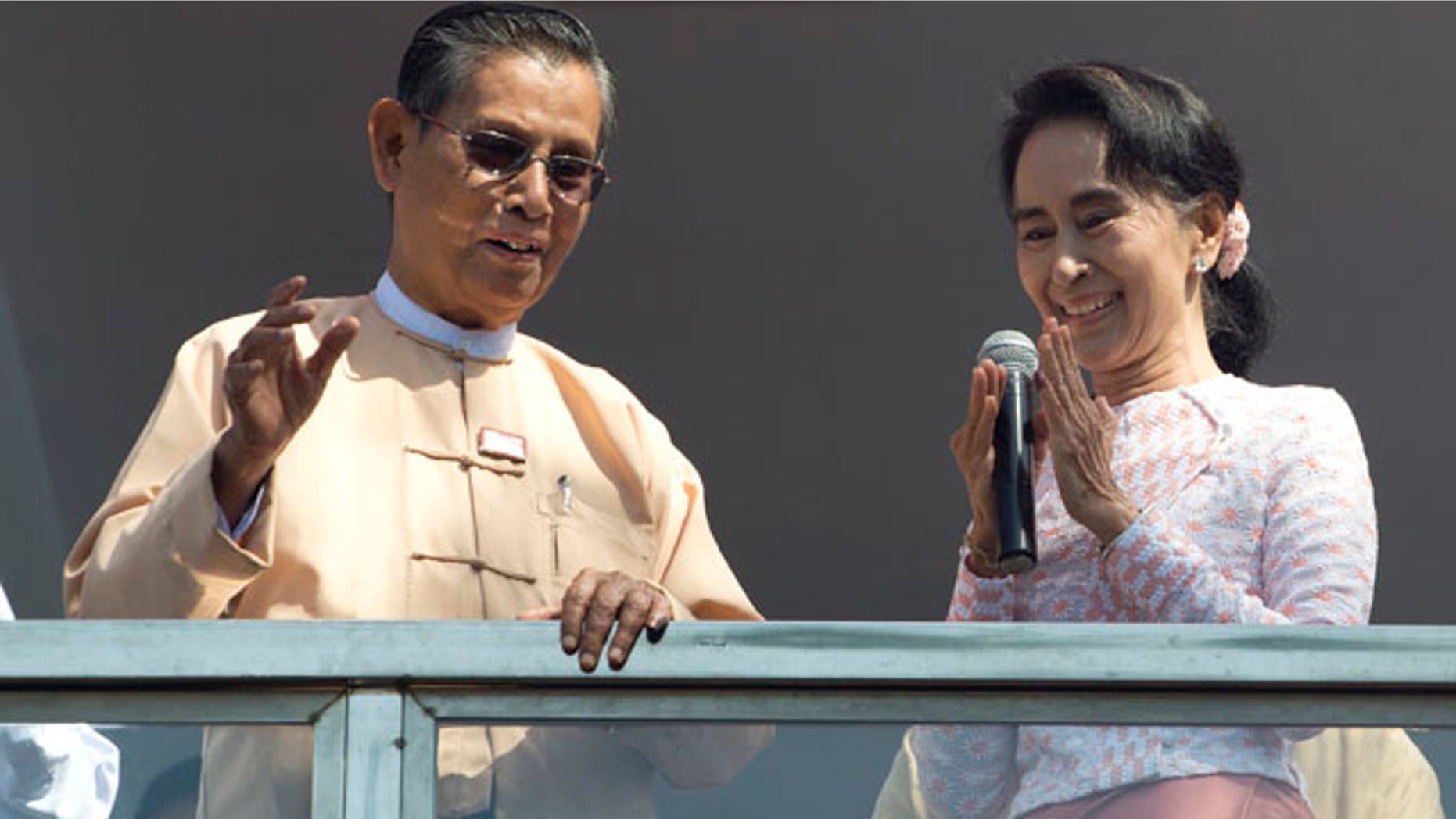 Nov. 9, 2015: Aung San Suu Kyi, the leader of Burma's National League for Democracy party, delivers a speech with party patron Tin Oo from a balcony of her party's headquarters in Yangon. (AP Photo/Mark Baker)