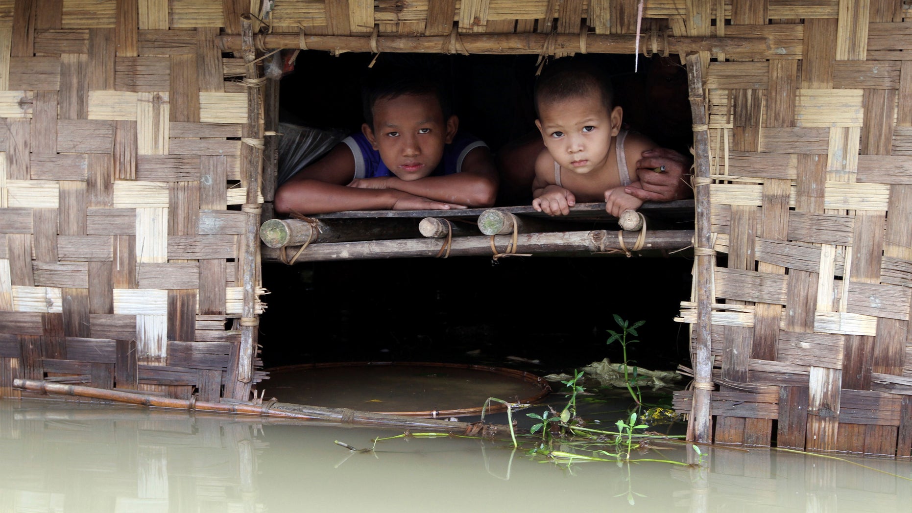 Aug. 17, 2012: Children look out from their house half-submerged in a low-lying area flooded by the Nga-Wun River in Ah-Thouk township, Ayeyarwaddy Delta, about 80 miles southwest of Yangon, Myanmar.