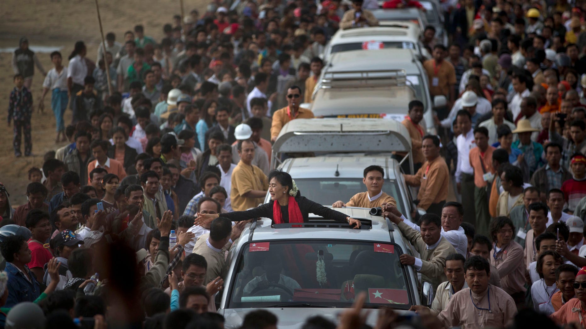 Nov. 30, 2012 - Opposition leader Aung San Suu Kyi reaches for supporters as she leaves after a public meeting close to Letpadaung mine in Monywa, northwestern Burma.