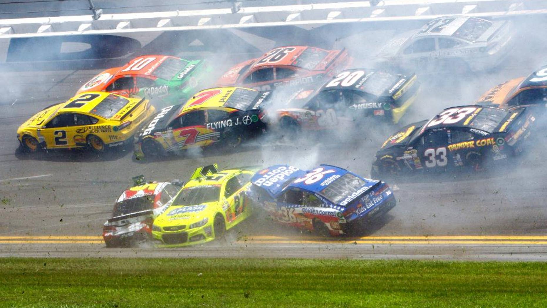 Kasey Kahne, front left, Paul Menard (27) and Reed Sorenson (36) are among the cars that crashed coming out of the backstretch going in to turn 3 during the NASCAR Sprint cup Series auto race at Daytona International Speedway in Daytona Beach, Fla., Sunday, July 6, 2014. (AP Photo/Ron Sanders)