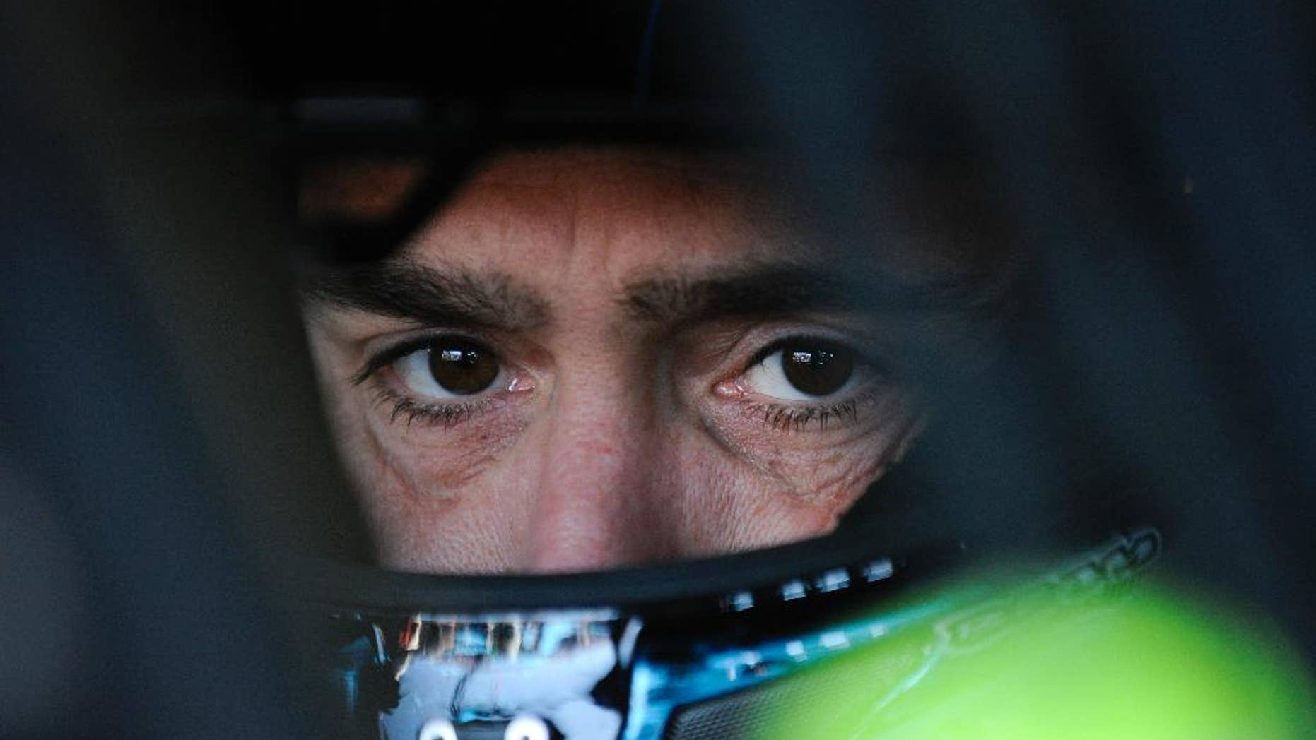 NASCAR driver Jimmie Johnson sits in his car as he waits to practice for Sunday's NASCAR Sprint Cup Series auto race at Talladega Superspeedway Friday, Oct. 17, 2014, in Talladega, Ala. Johnson has one shot to keep his bid for a record-tying seventh championship going. The defending NASCAR champion must win at Talladega to avoid elimination from the Chase. (AP Photo/Rainier Ehrhardt)