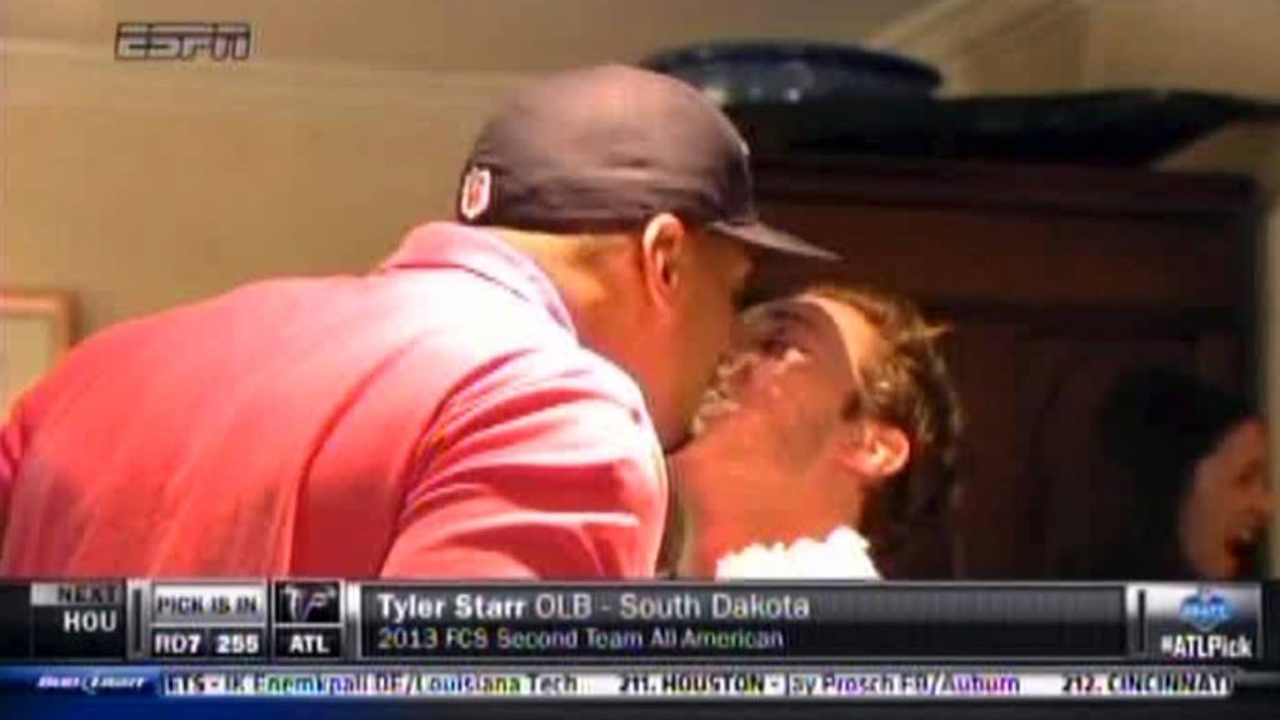 In this image taken from video, Missouri defensive end Michael Sam, left, gets a kiss at a draft party in San Diego, before he was selected in the seventh round, 249th overall, by the St. Louis Rams in the NFL draft Saturday, May 10, 2014. The Southeastern Conference defensive player of the year last season came out as gay in media interviews this year. (AP Photo/ESPN)