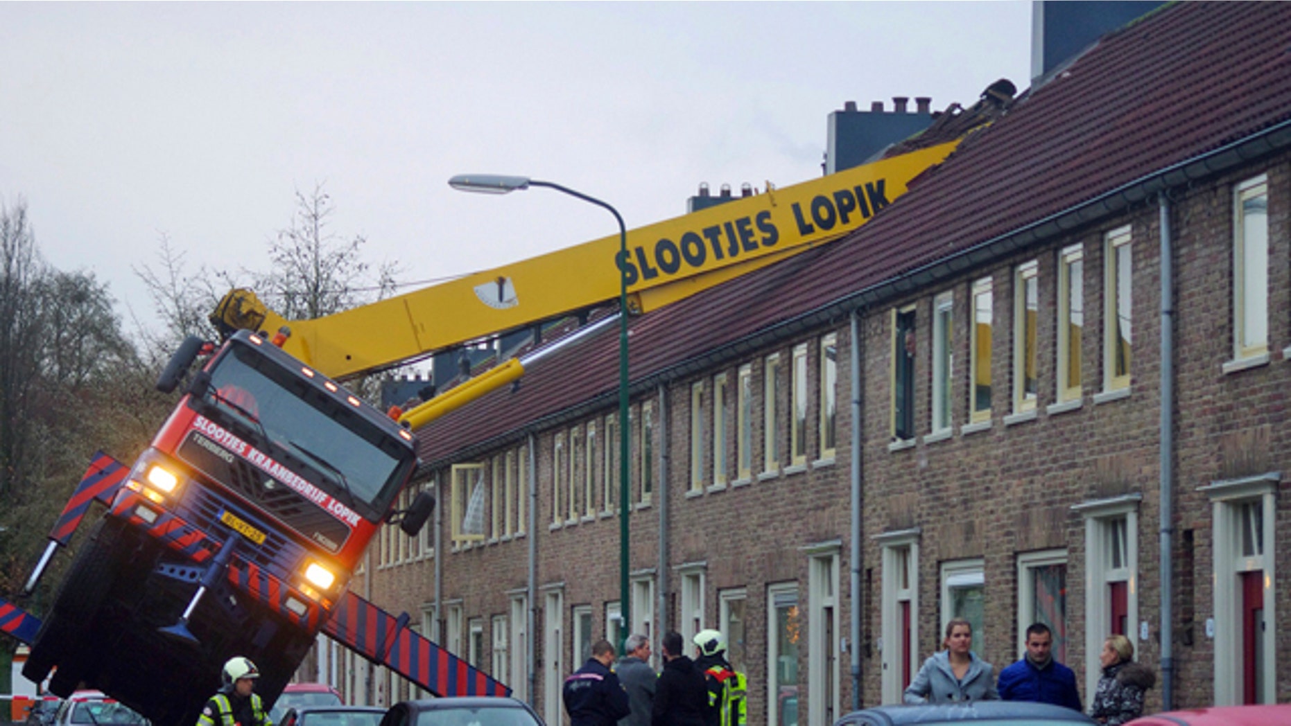 December 13, 2014: A crane which crashed into the roof of a house is seen following an unusual marriage proposal by a man who wished to be lifted in front of the bedroom window of his girlfriend to ask for her hand in marriage, in the Dutch town of IJsselstein. (AP/AS Media)
